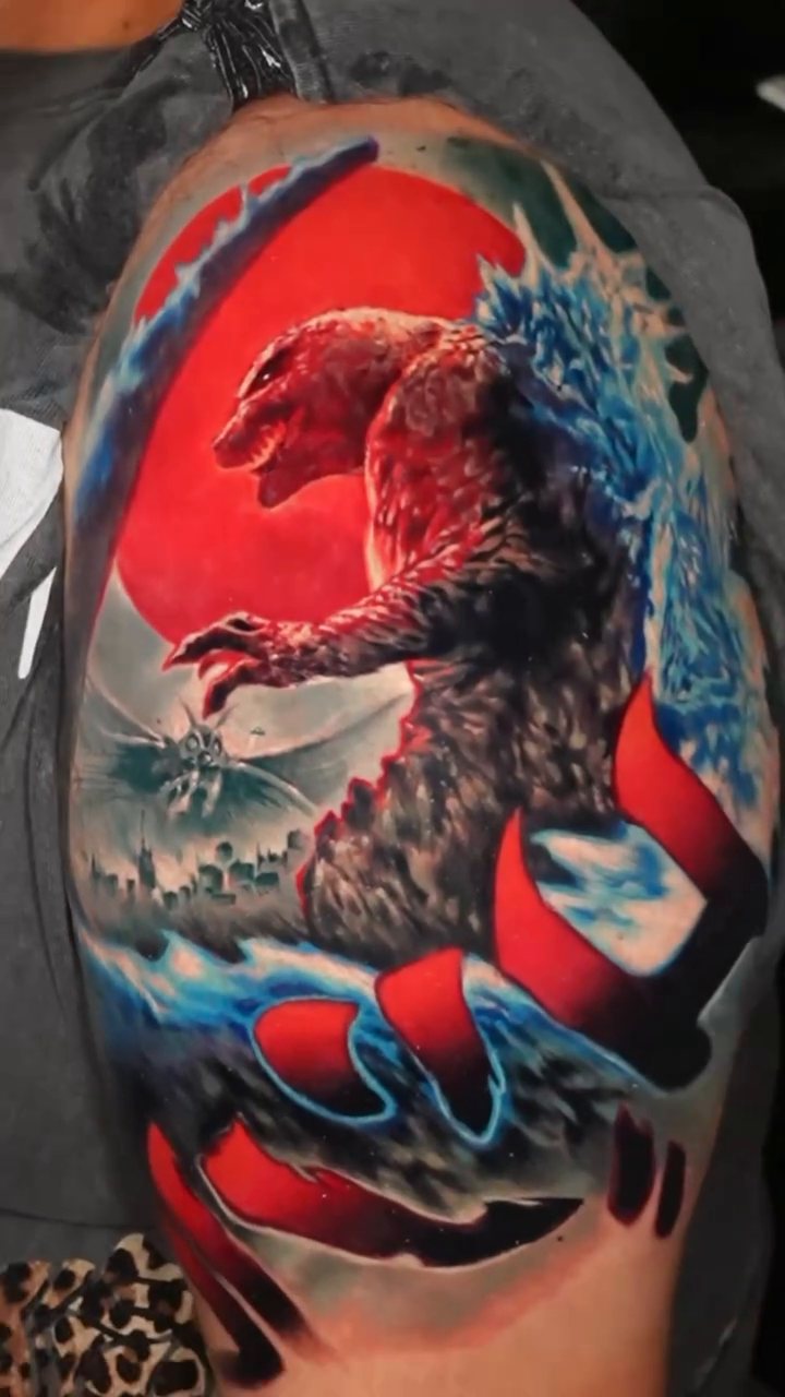 Godzilla attacking a city realism tattoo by Ben Ochoa