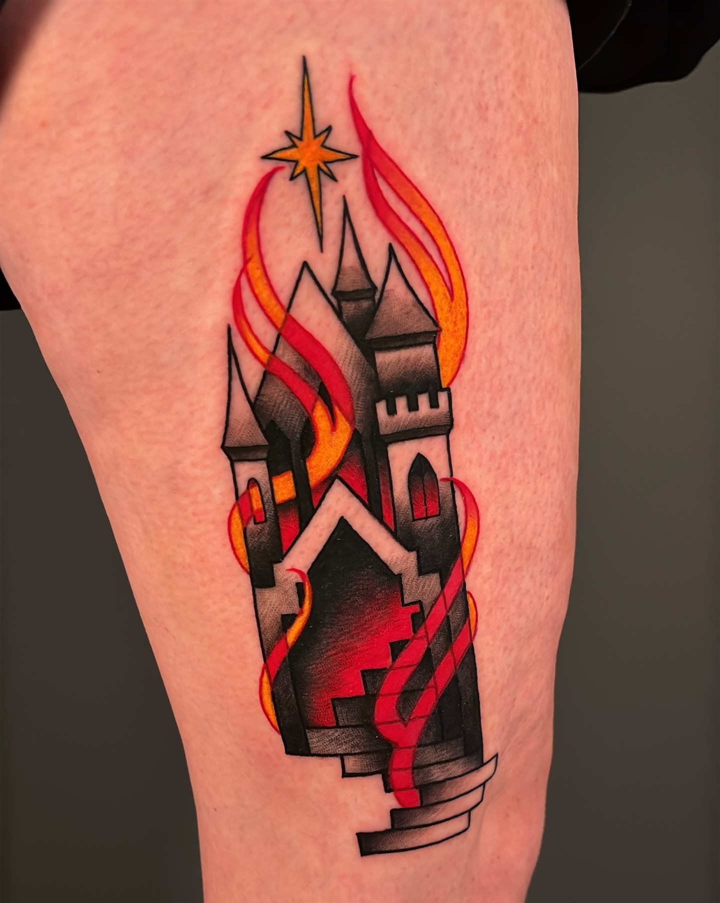 Castle with flames American traditional tattoo on the thigh by Latesha Burnley