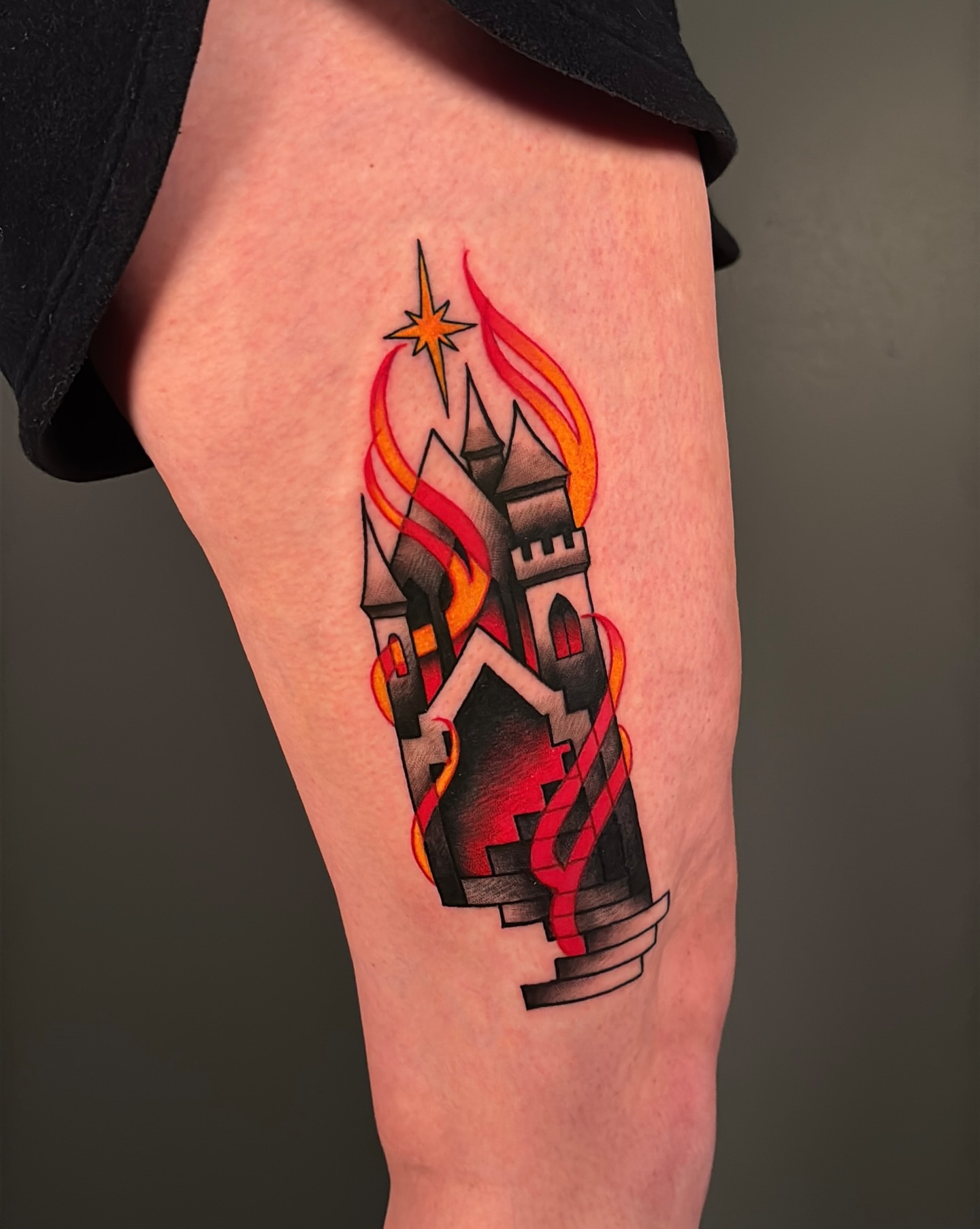 Castle with flames American traditional tattoo on the thigh by Latesha Burnley