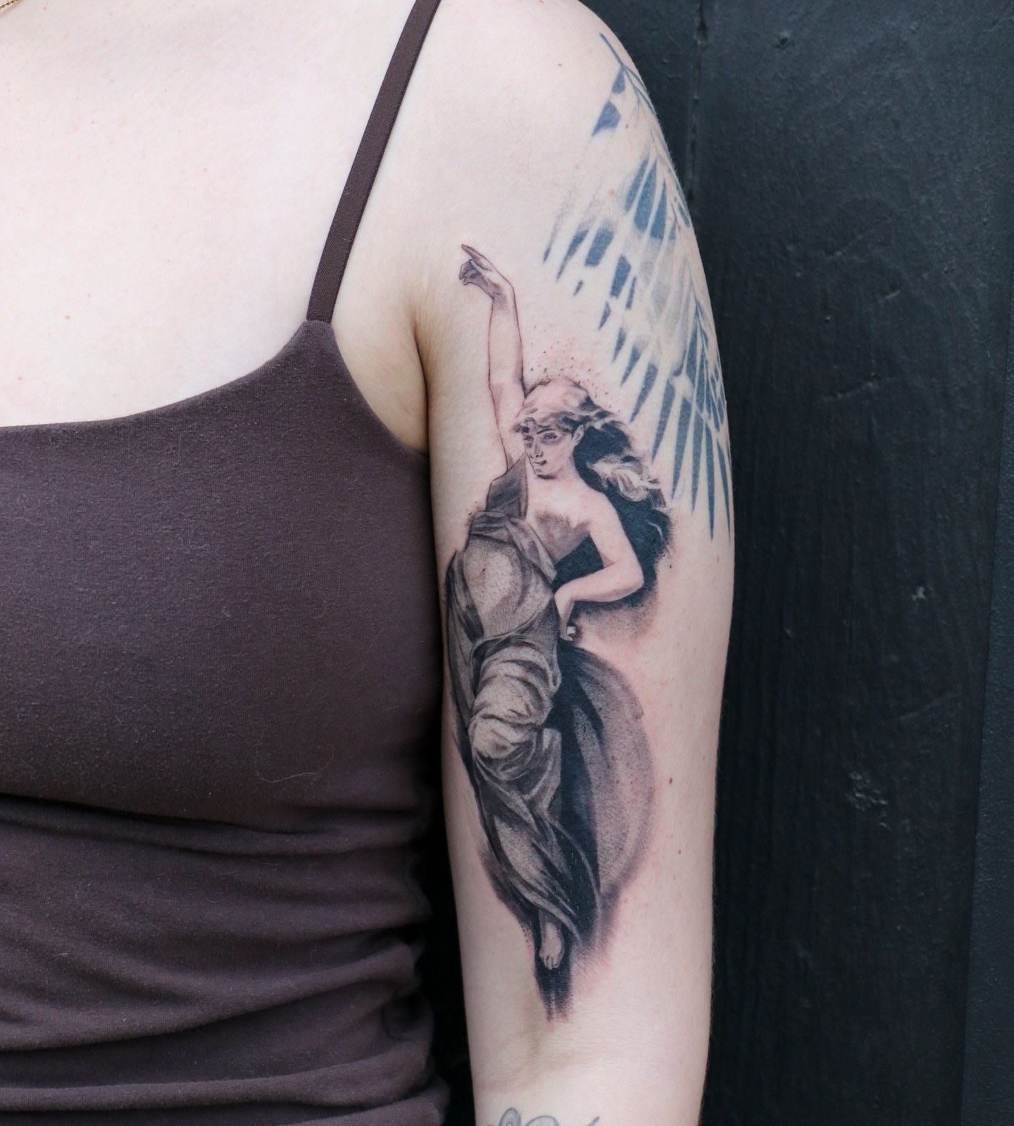 Statue of woman realism tattoo on the upper arm by Jhenn