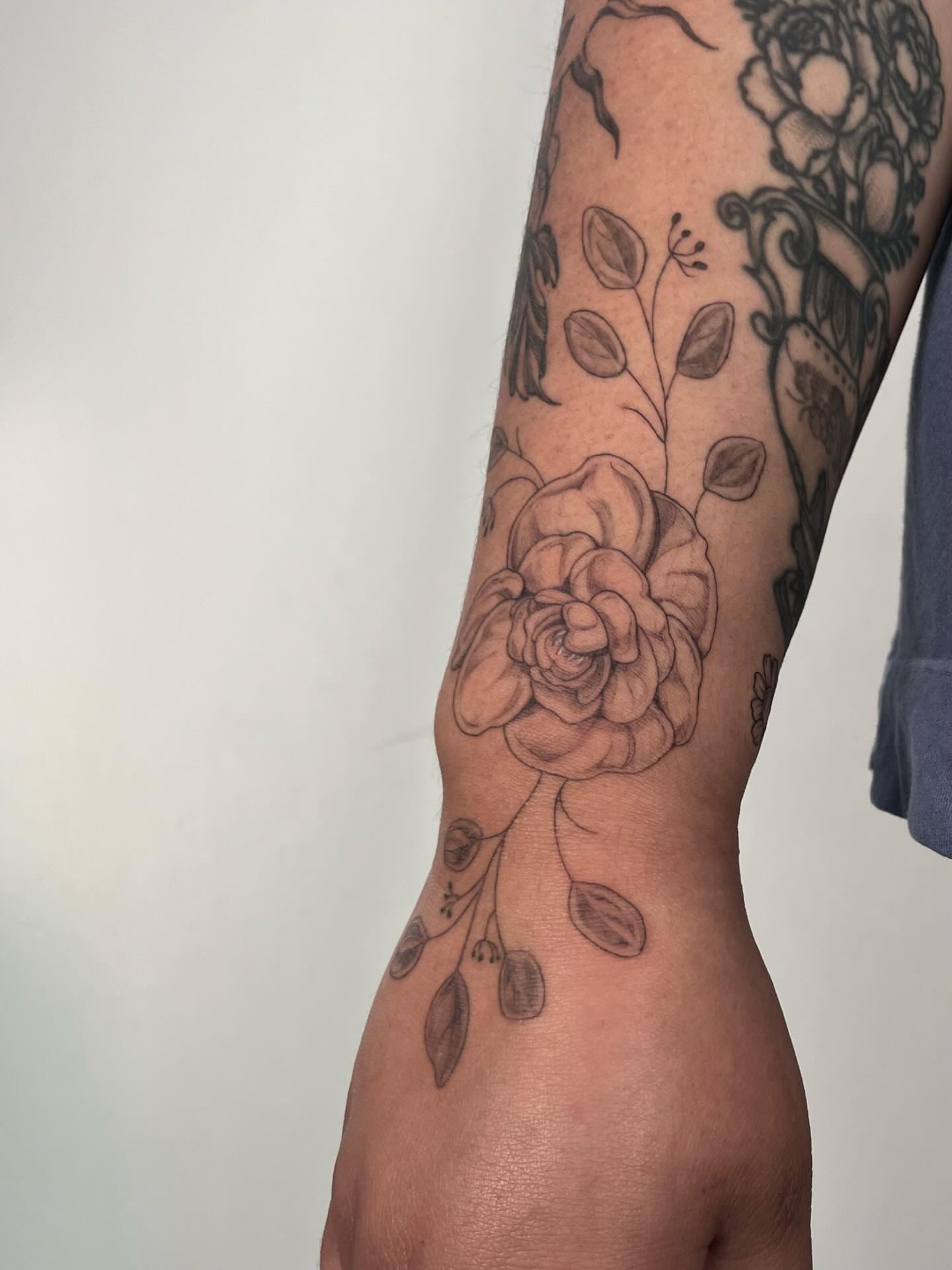 Flower black and grey tattoo on the forearm by Sierra Skye
