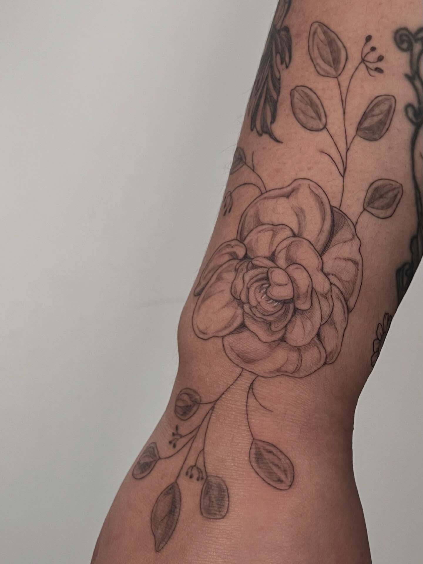 Rose black and grey tattoo on the forearm by Sierra Skye