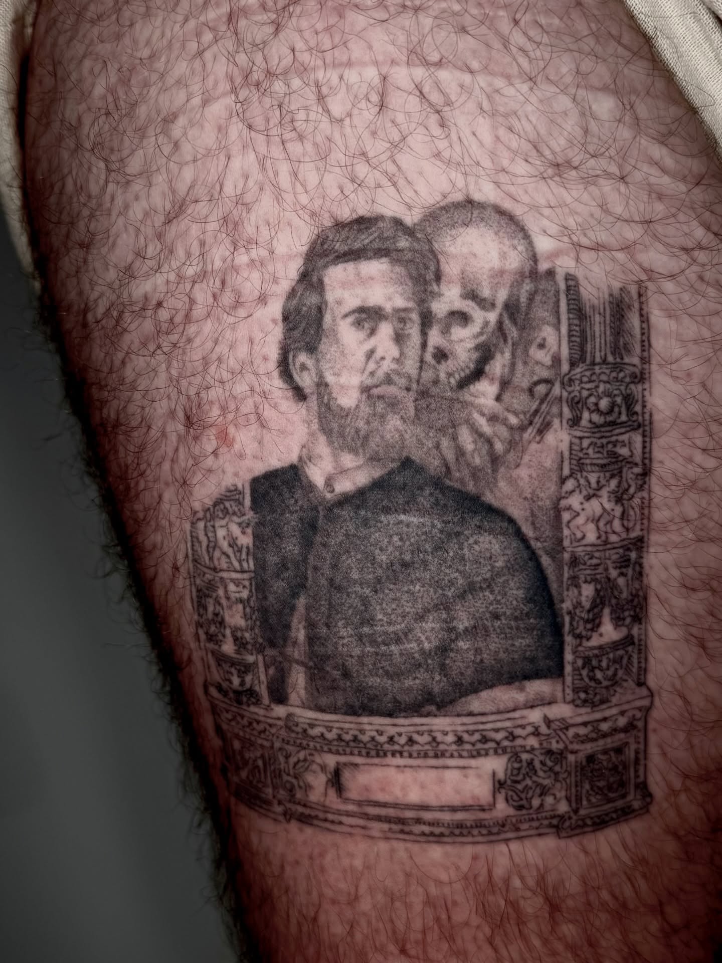 Man and skull black and grey tattoo on the thigh by Ian Saner