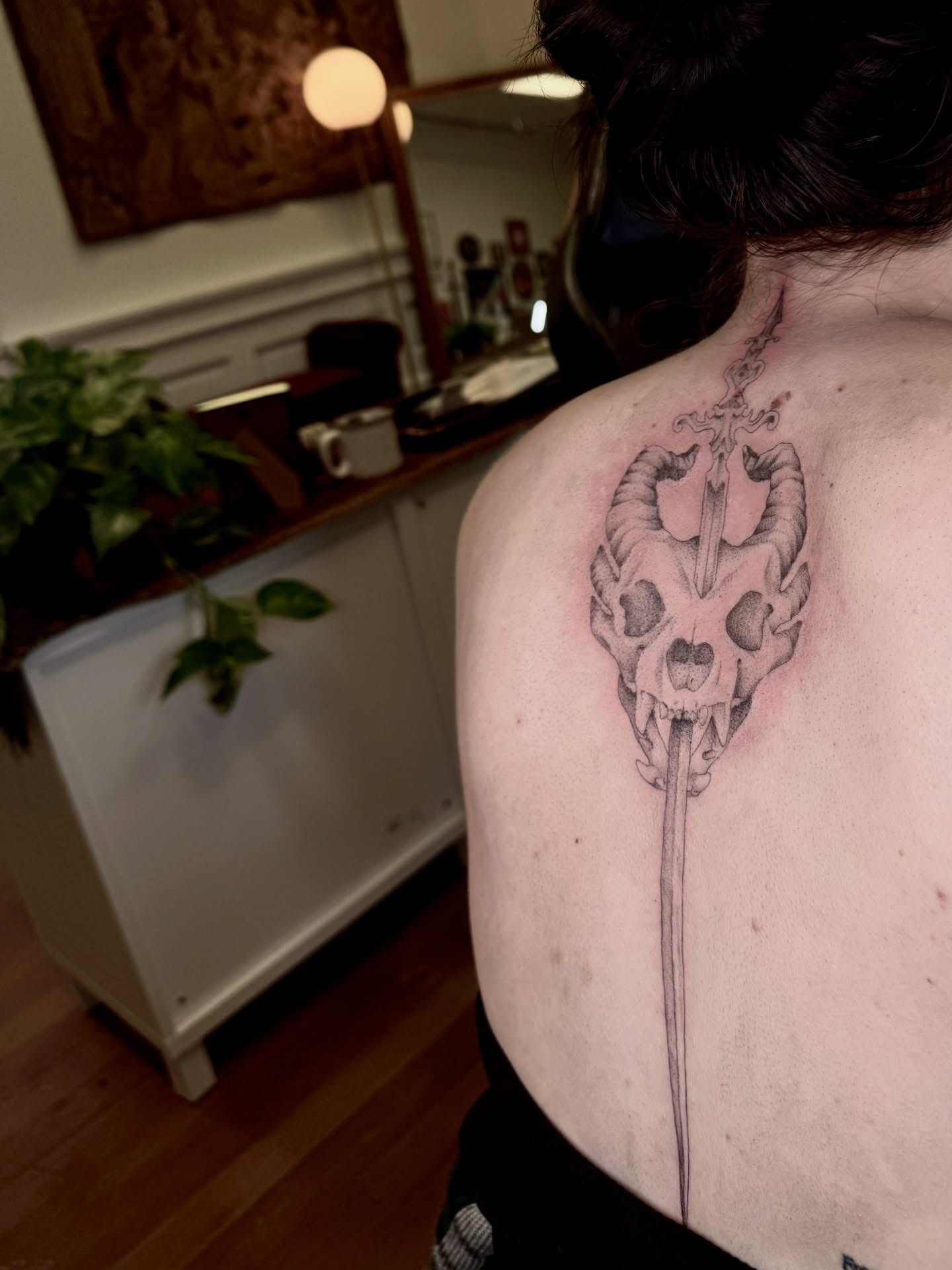 Ram skull with sword realism tattoo on the shoulder by Ian Saner