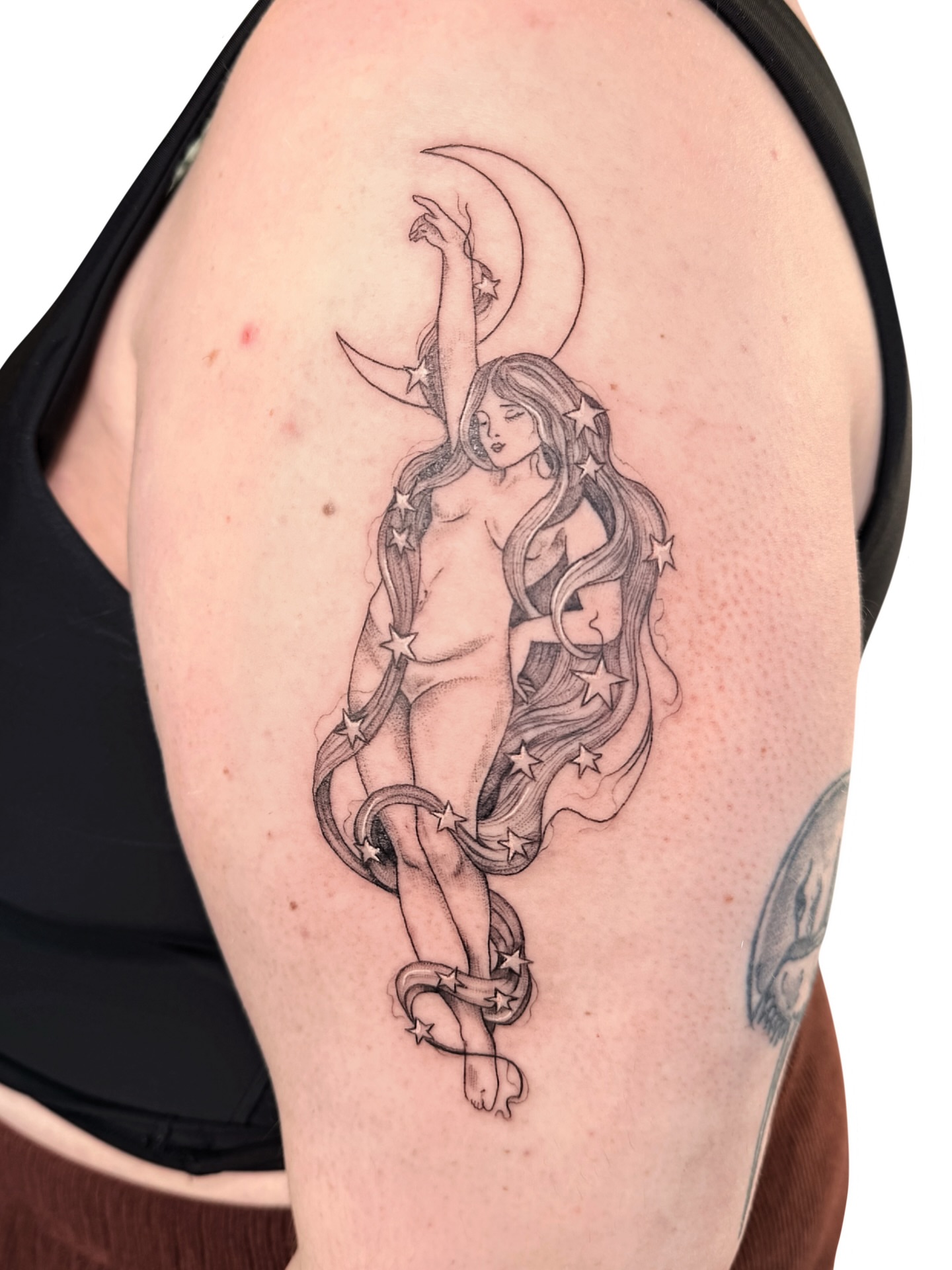 Nude woman and stars realism tattoo on the shoulder by Fionna, Seattle, Washington