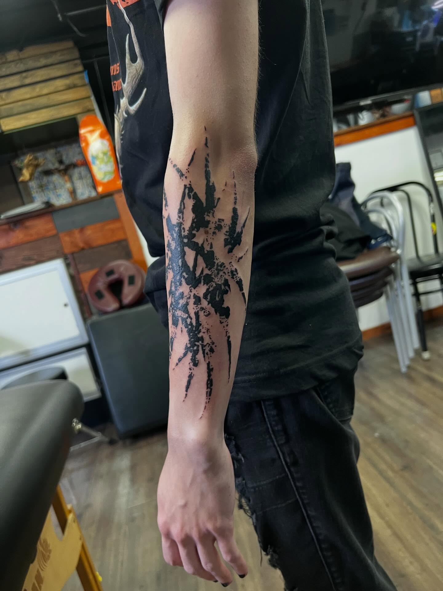 Abstract splatter dotwork tattoo on the forearm by @halfwit__
