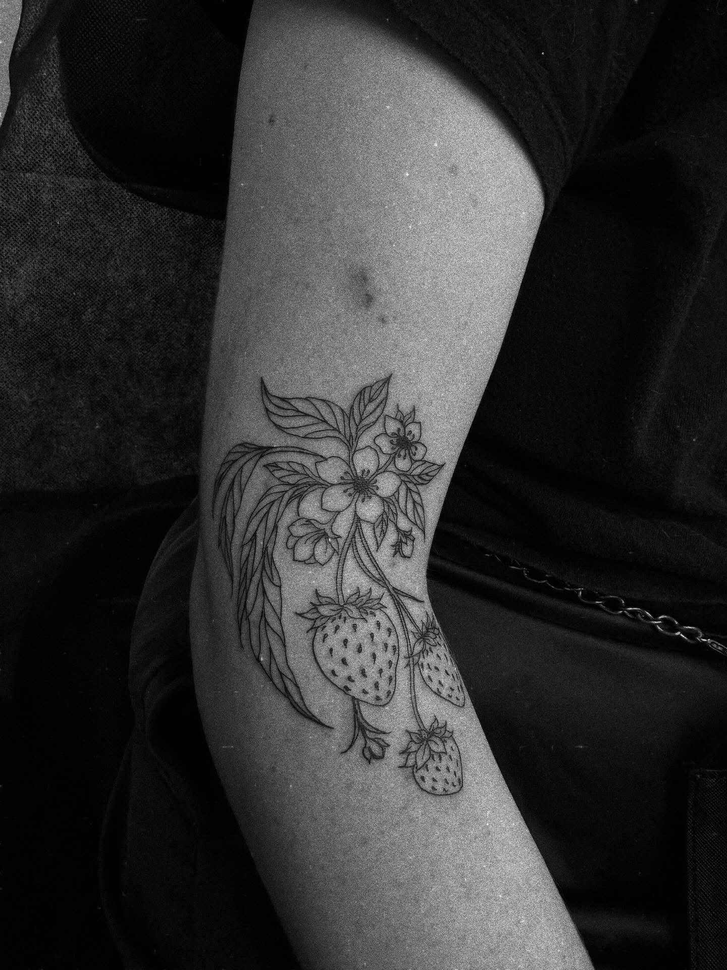 Strawberries and flowers black and grey tattoo on the forearm by Kraken ink Tattoo, San Francisco, California
