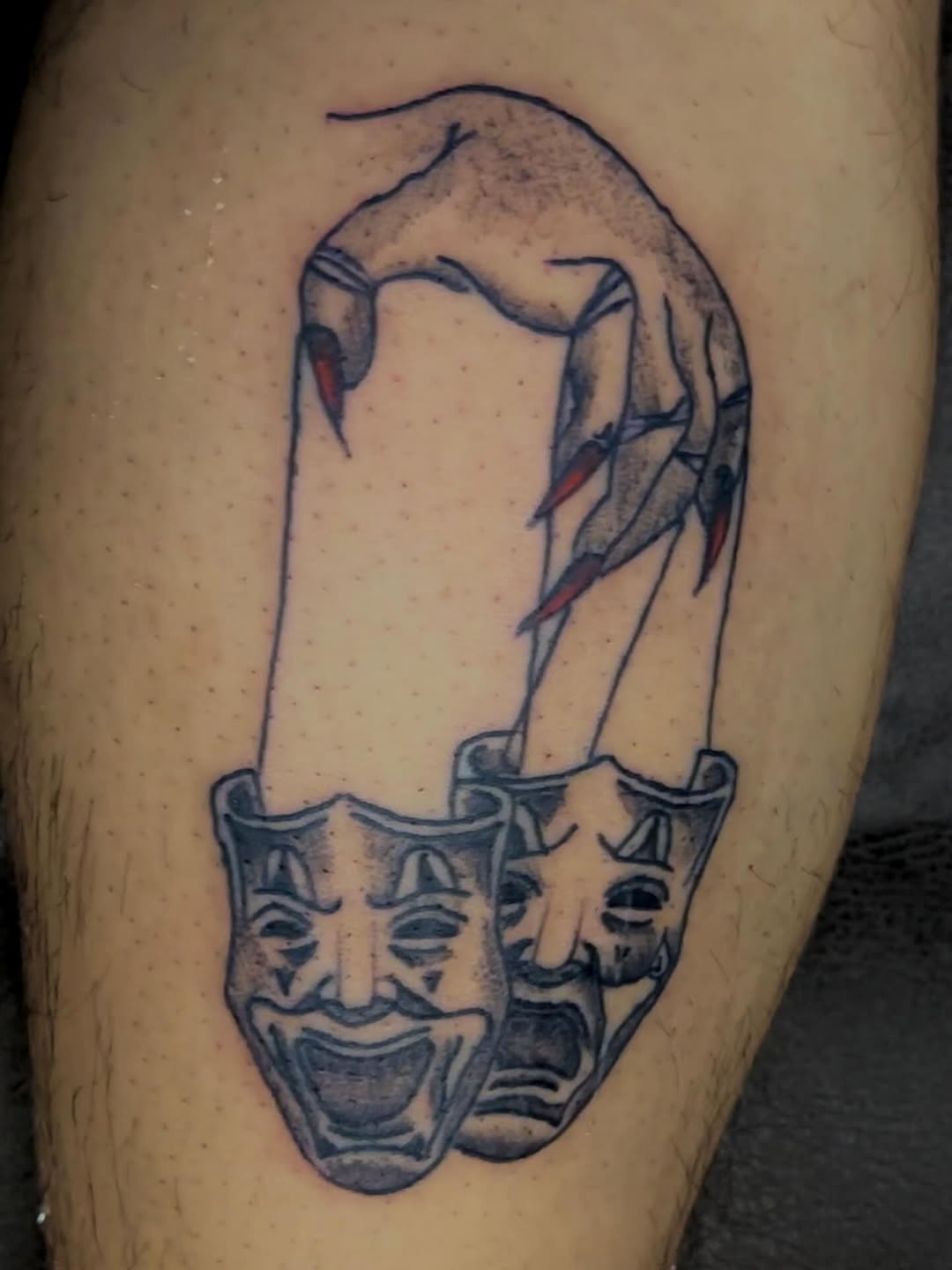 Hand controlling comedy and tragedy masks realism tattoo on the forearm by MY$T