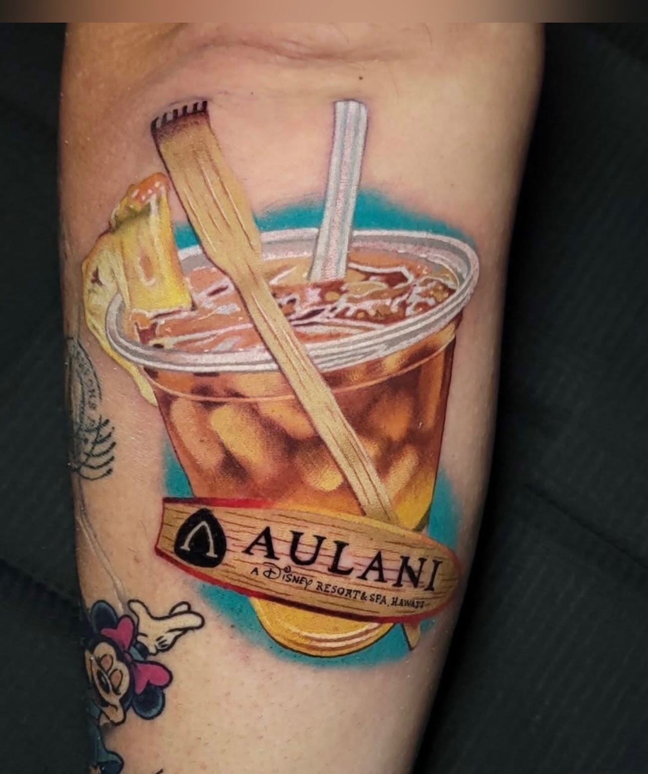 Aulani drink realism tattoo on the forearm by Melissa Does Tattoos - Bright, Bold Anime &