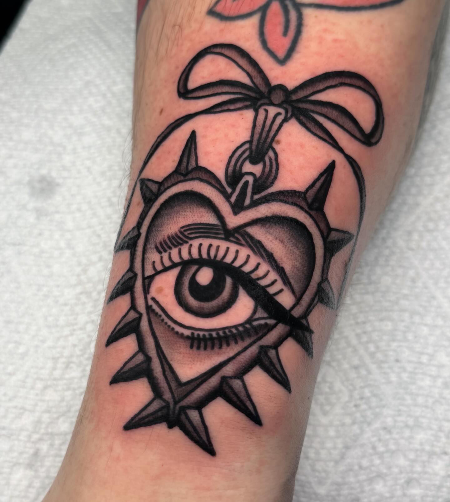 Eye with spikes American traditional tattoo on the forearm by ⭐️ Erin Bauer ⭐️
