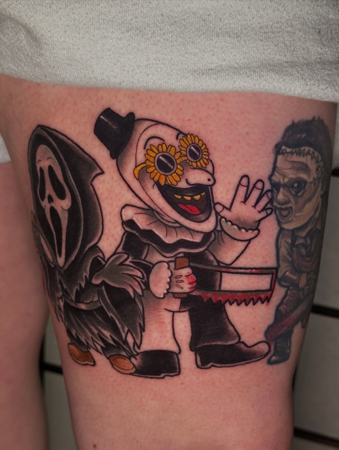 Clown with saw realism tattoo on the thigh by Robert Douglas