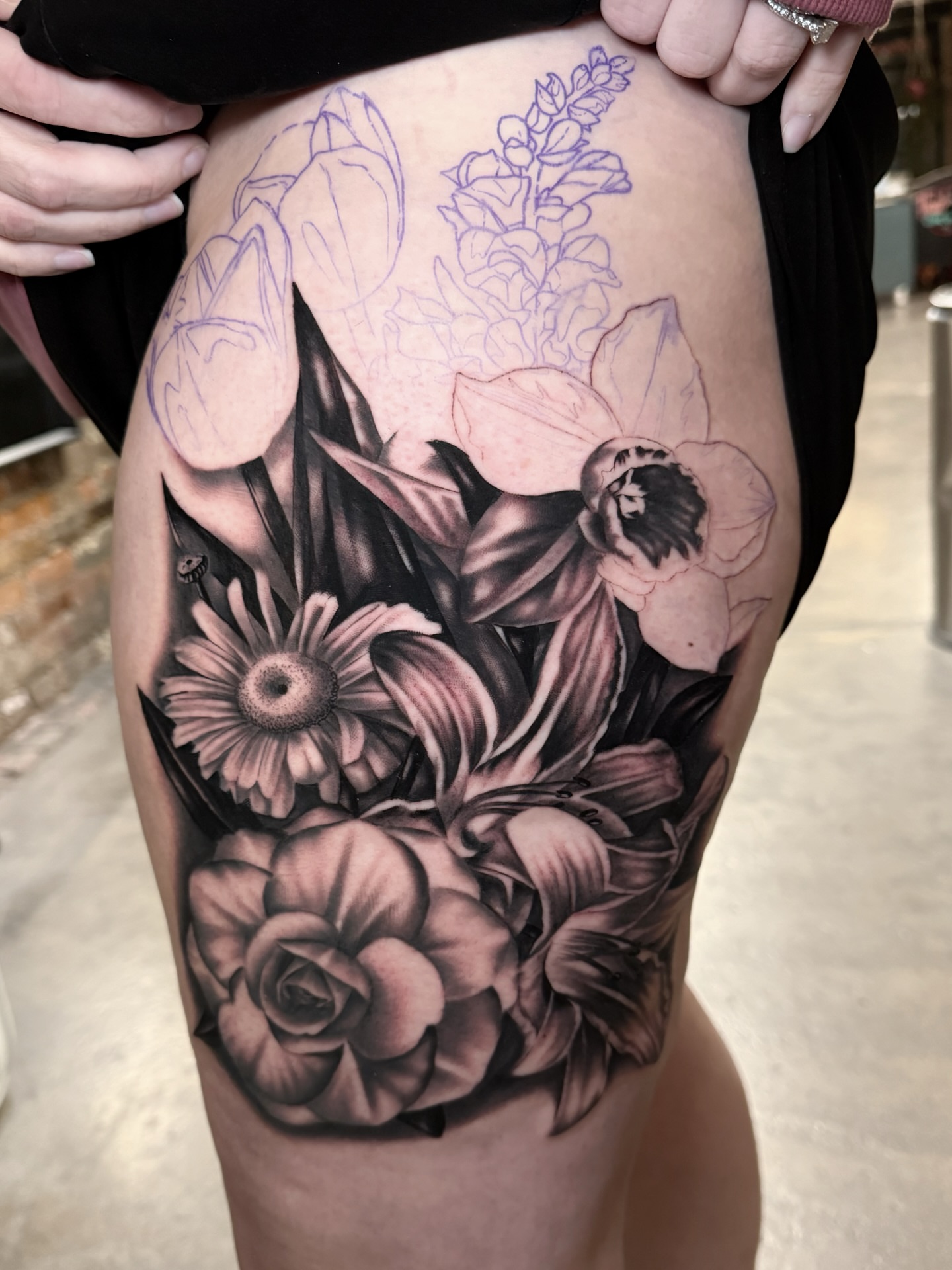 Floral arrangement realism tattoo on the thigh by Matt Misiak