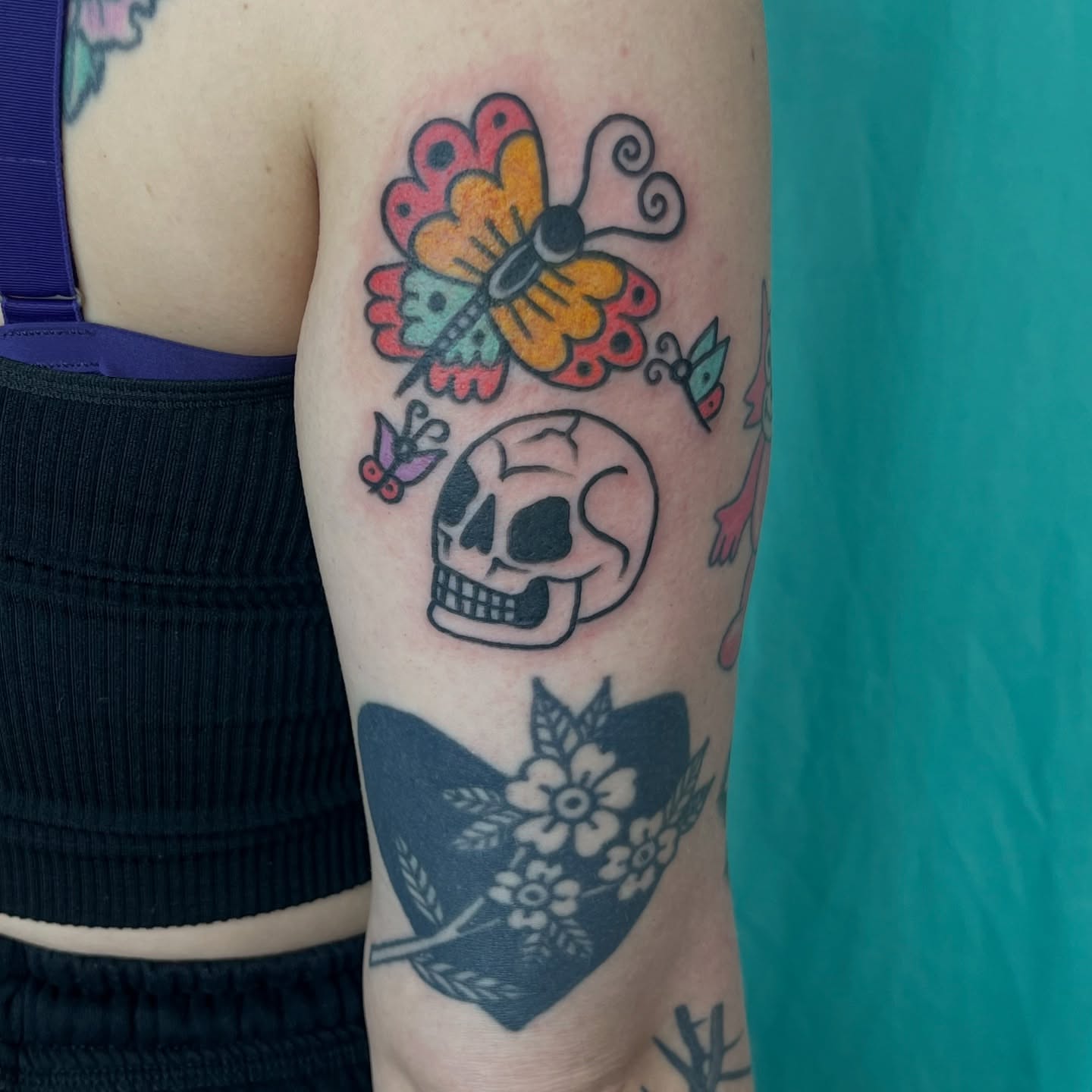 Skull and butterfly American traditional tattoo on the forearm by Kaily McKee