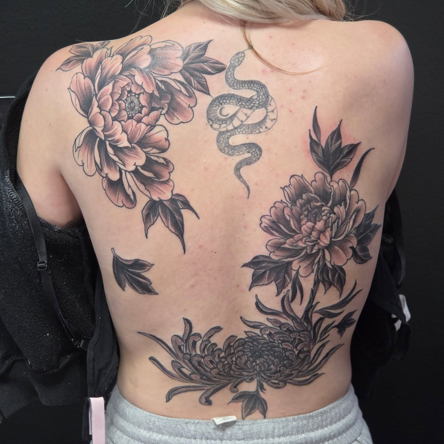 Snake and peony black and grey tattoo on the back by Robert Glover