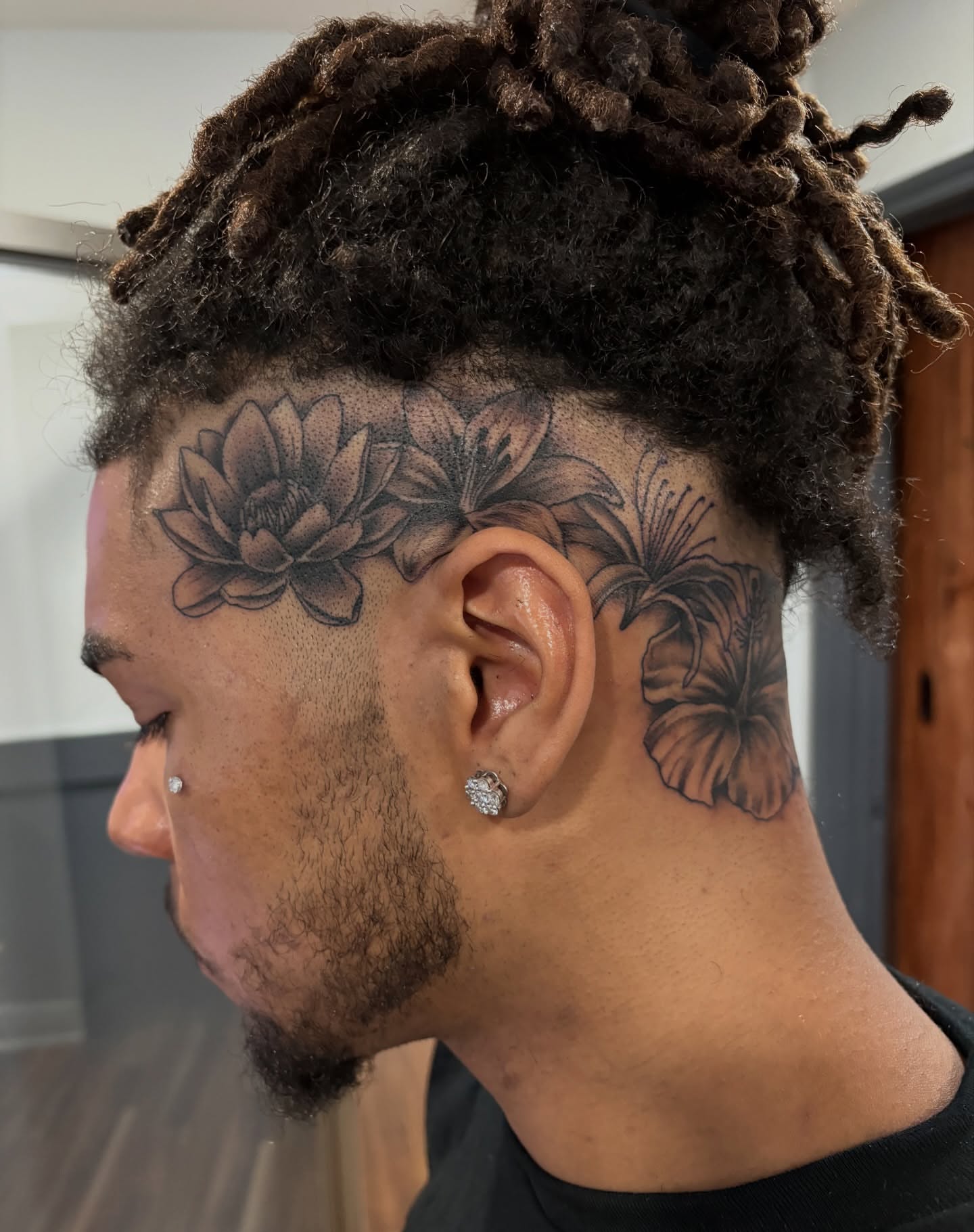 Lotus flowers black and grey tattoo on the neck by Blake