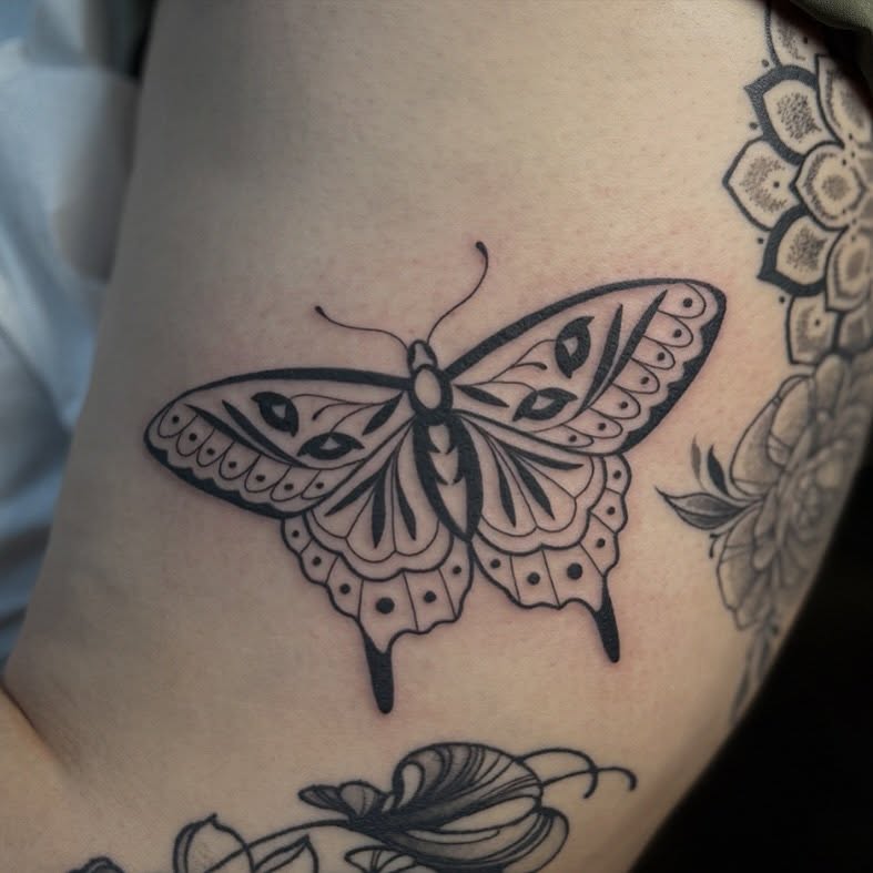 Butterfly black and grey tattoo on the thigh by Leah - Tattoo Artist