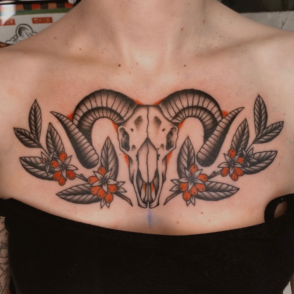 Ram skull with floral wreath realism tattoo on the chest by Will Allan Columbus tattoo artist