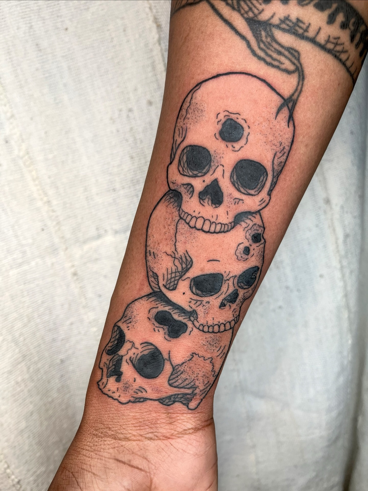 Skulls black and grey tattoo on the forearm by Maris Hare, Philadelphia, Pennsylvania