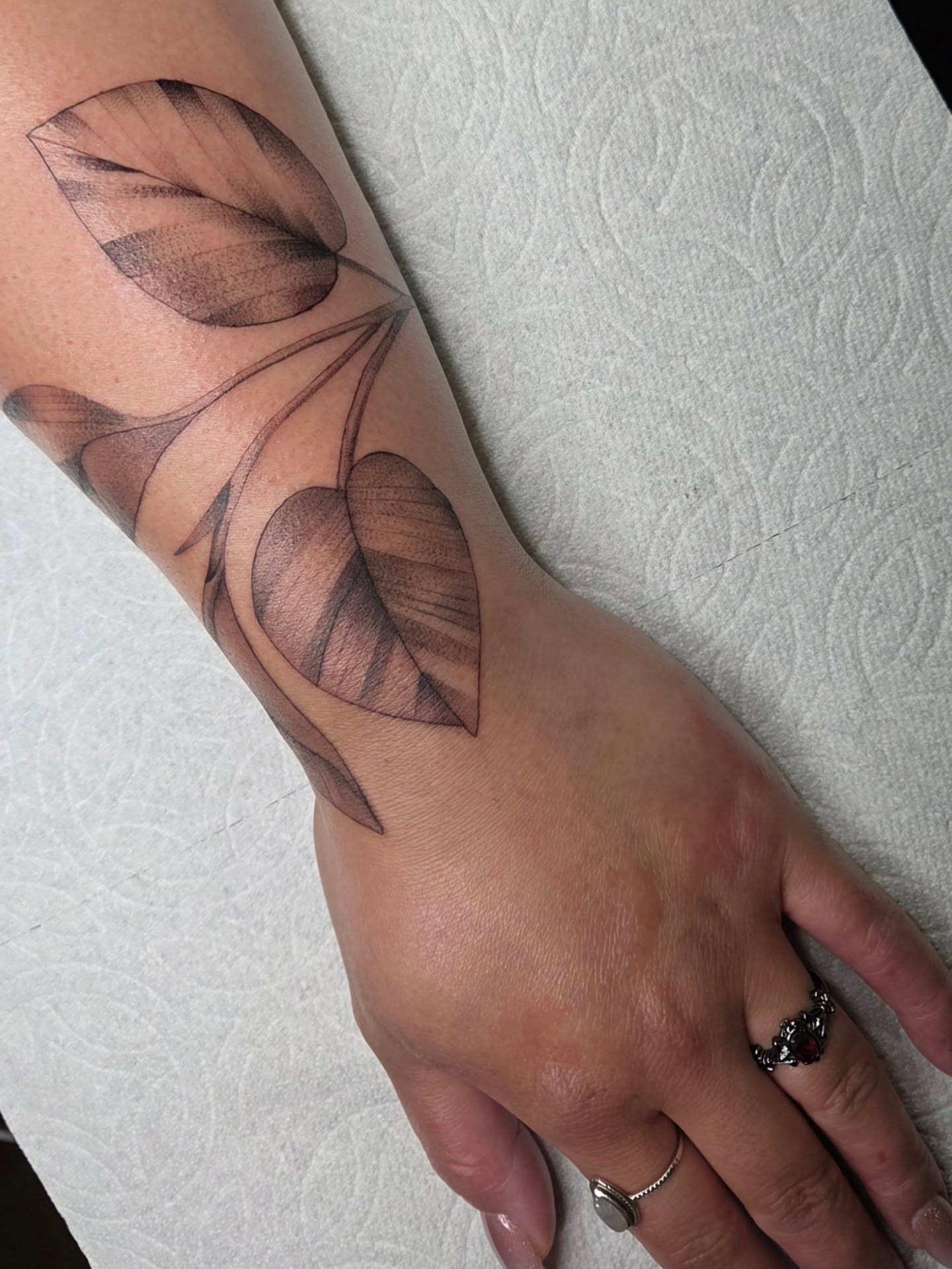 Leaf black and grey tattoo on the forearm by Yvette Cebreros
