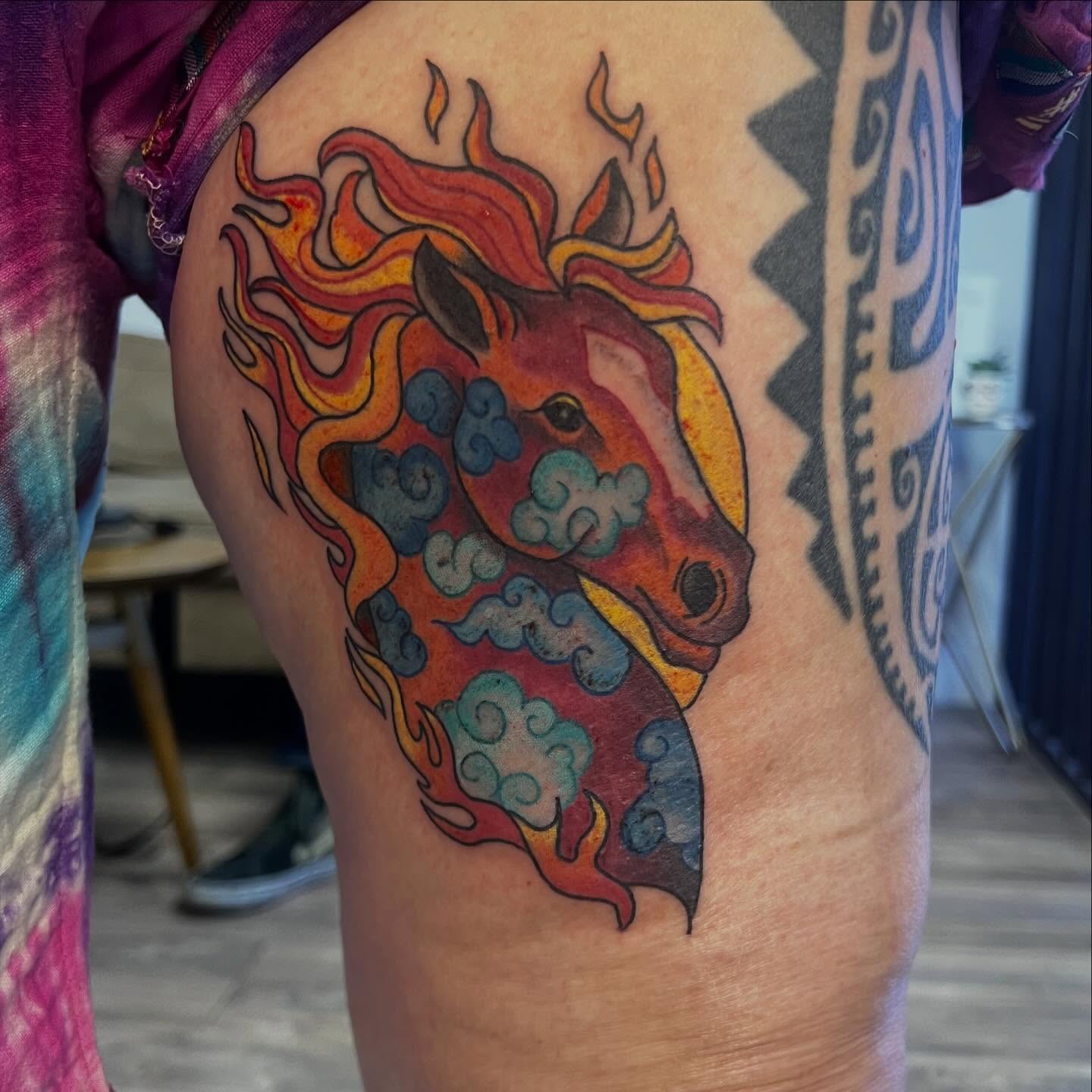Flaming horse new school tattoo on the thigh by Victorian Coleman