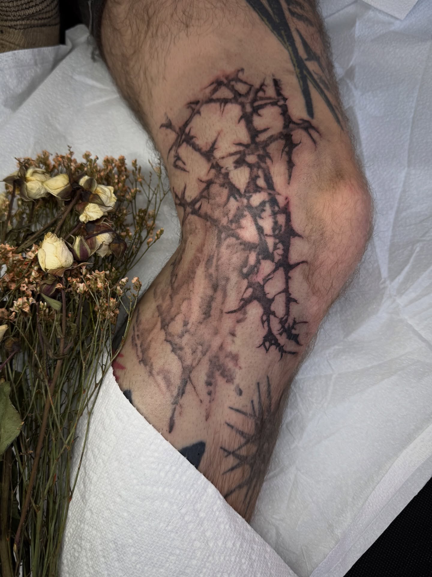 Thorn branch black and grey tattoo on the forearm by Jamie Draven 🐺