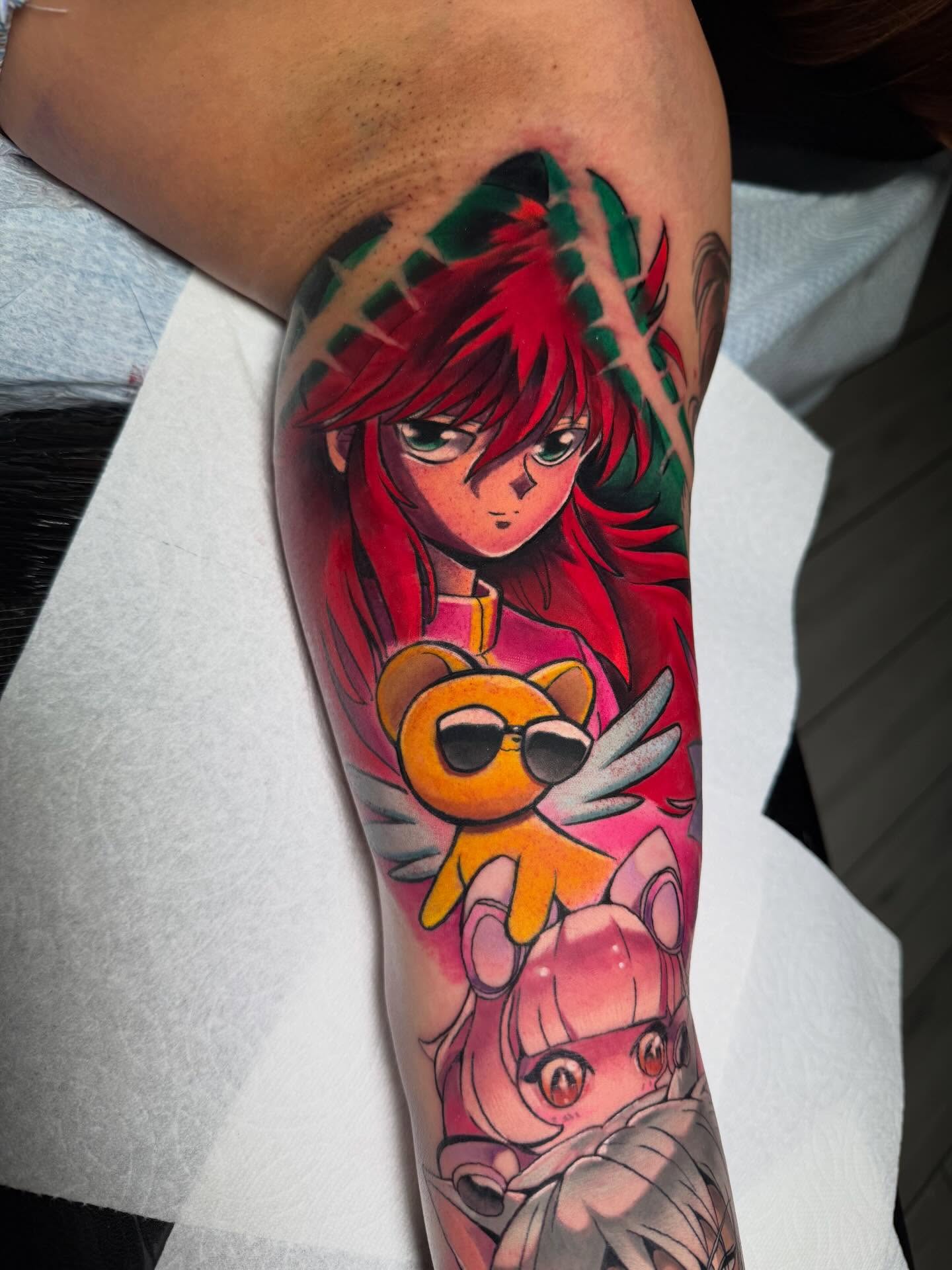 Anime characters anime tattoo on the forearm by Kenneth Ruiz