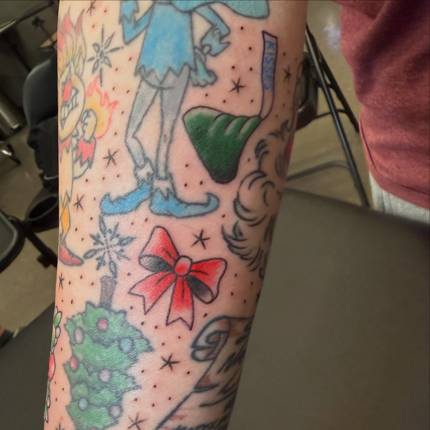 Christmas-themed dotwork tattoo on the forearm by ArJay Smith