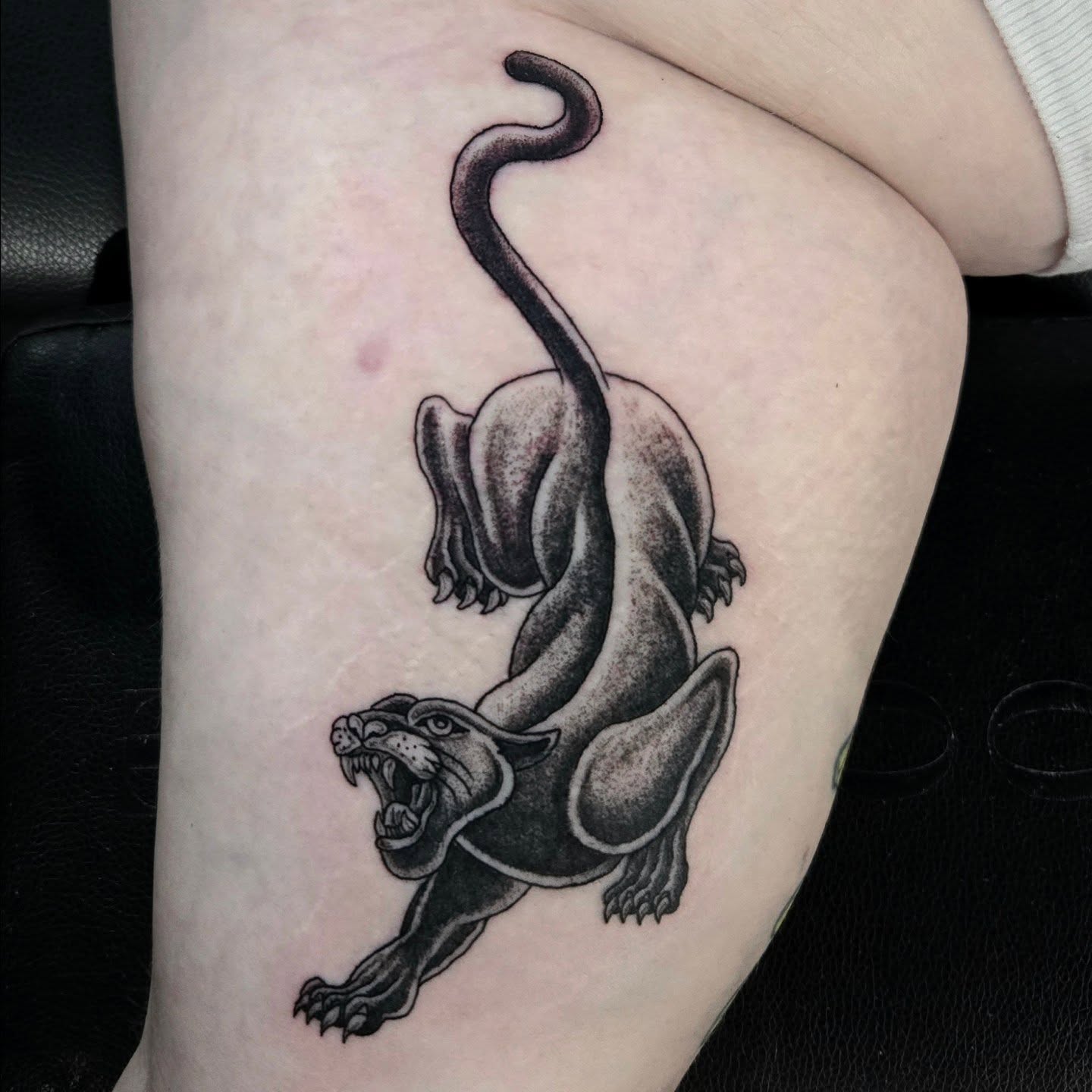 Panther black and grey tattoo on the thigh by Perry