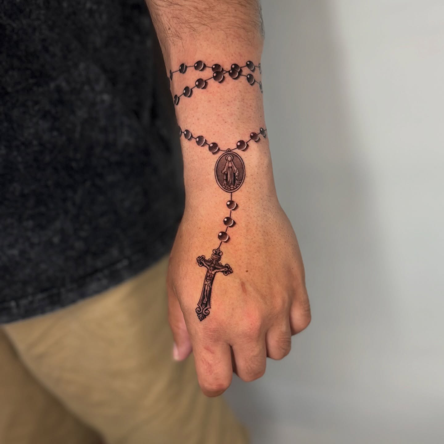 Rosary black and grey tattoo on the hand by Geo