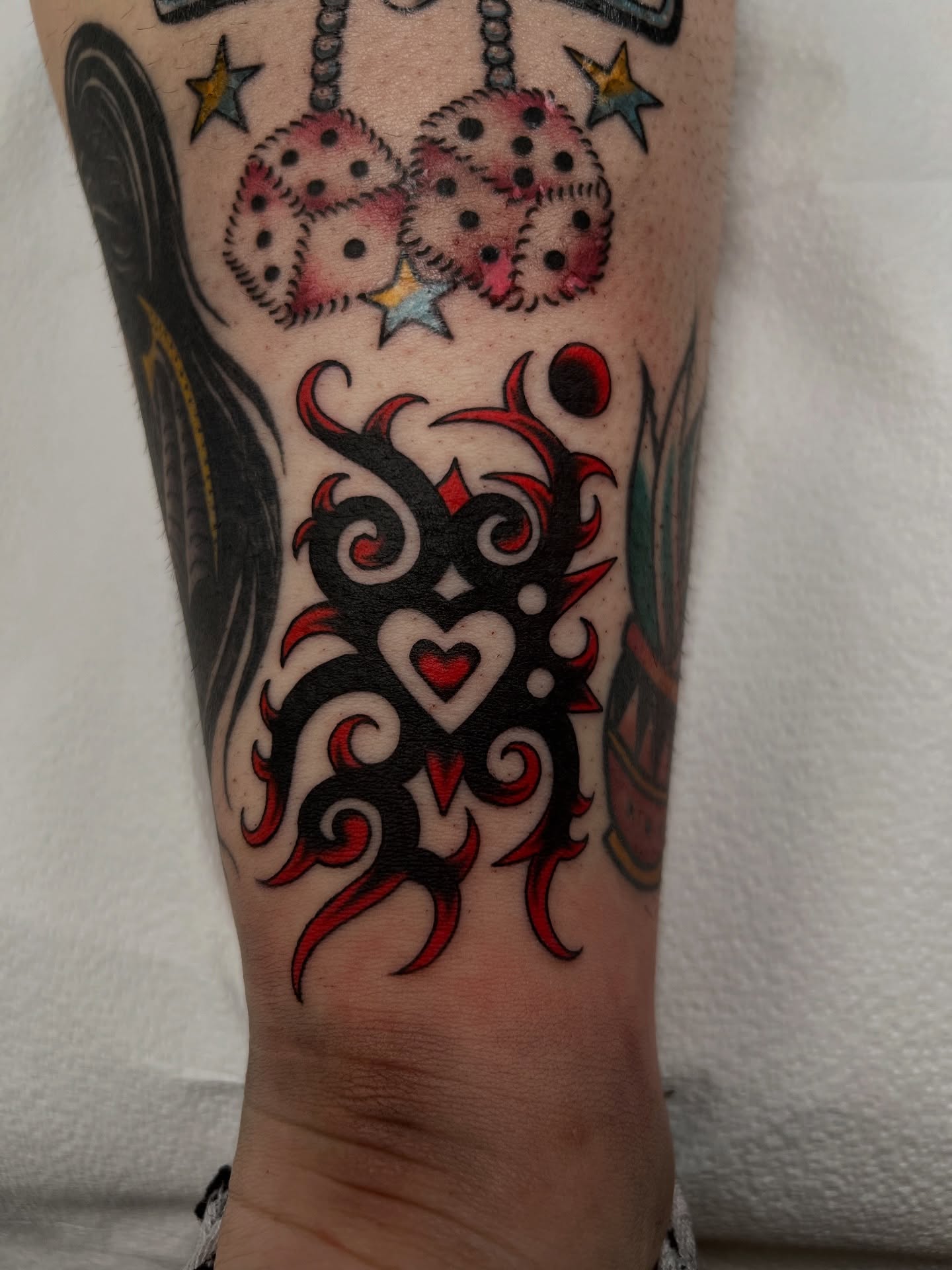Tribal heart tribal tattoo on the forearm by Cassidy Maples