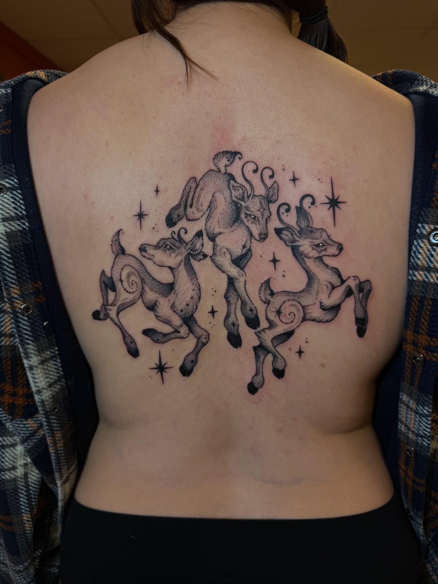Three deer black and grey tattoo on the back by Gianna Calisi