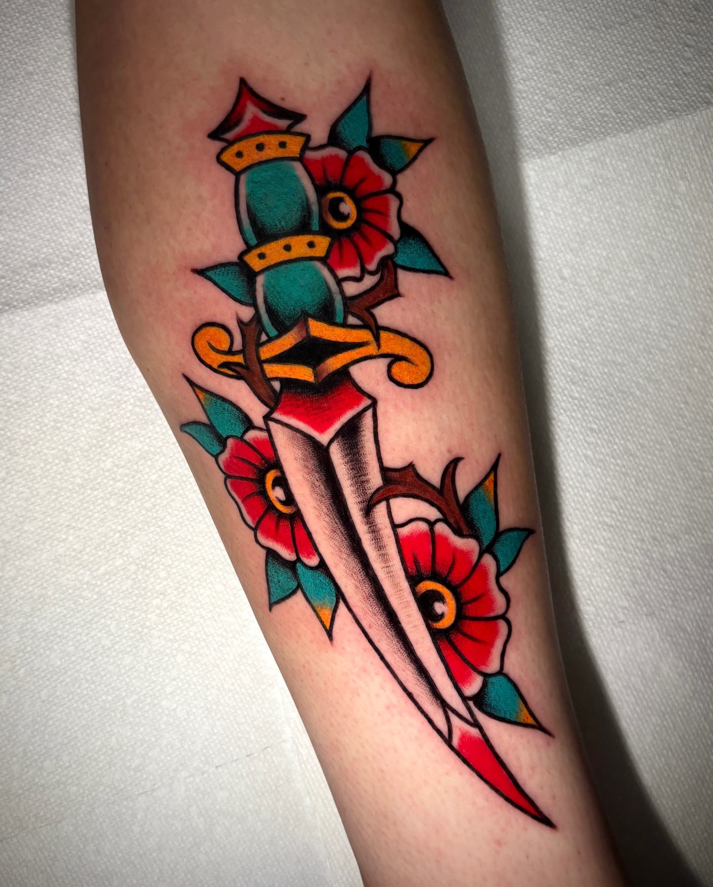 Knife and flowers American traditional tattoo on the forearm by Matt Elliott, Murfreesboro, Tennessee