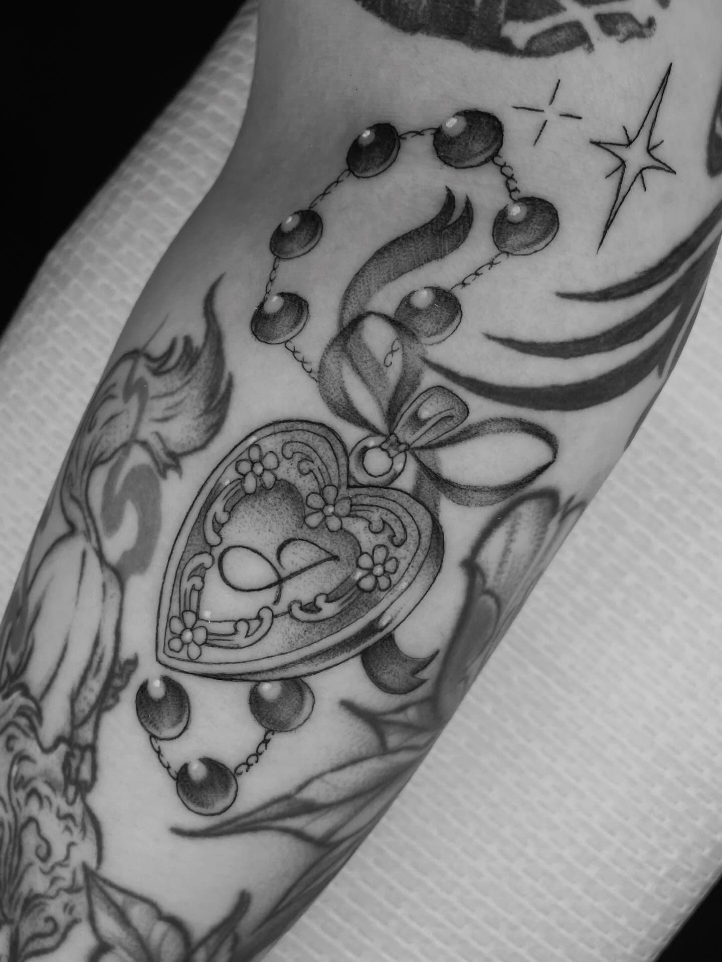 Heart locket American traditional tattoo on the forearm by Xena