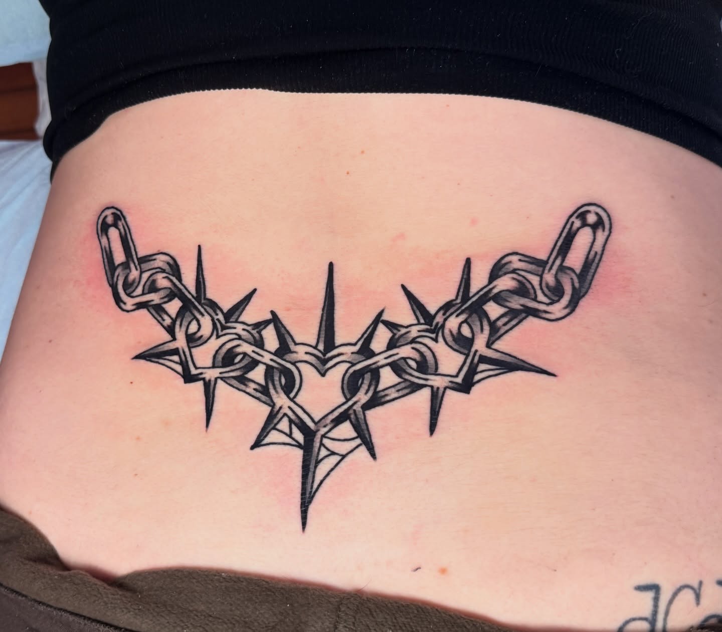 Barbed wire heart black and grey tattoo on the ribs by Stevie Lowenstein, Cincinnati, Ohio