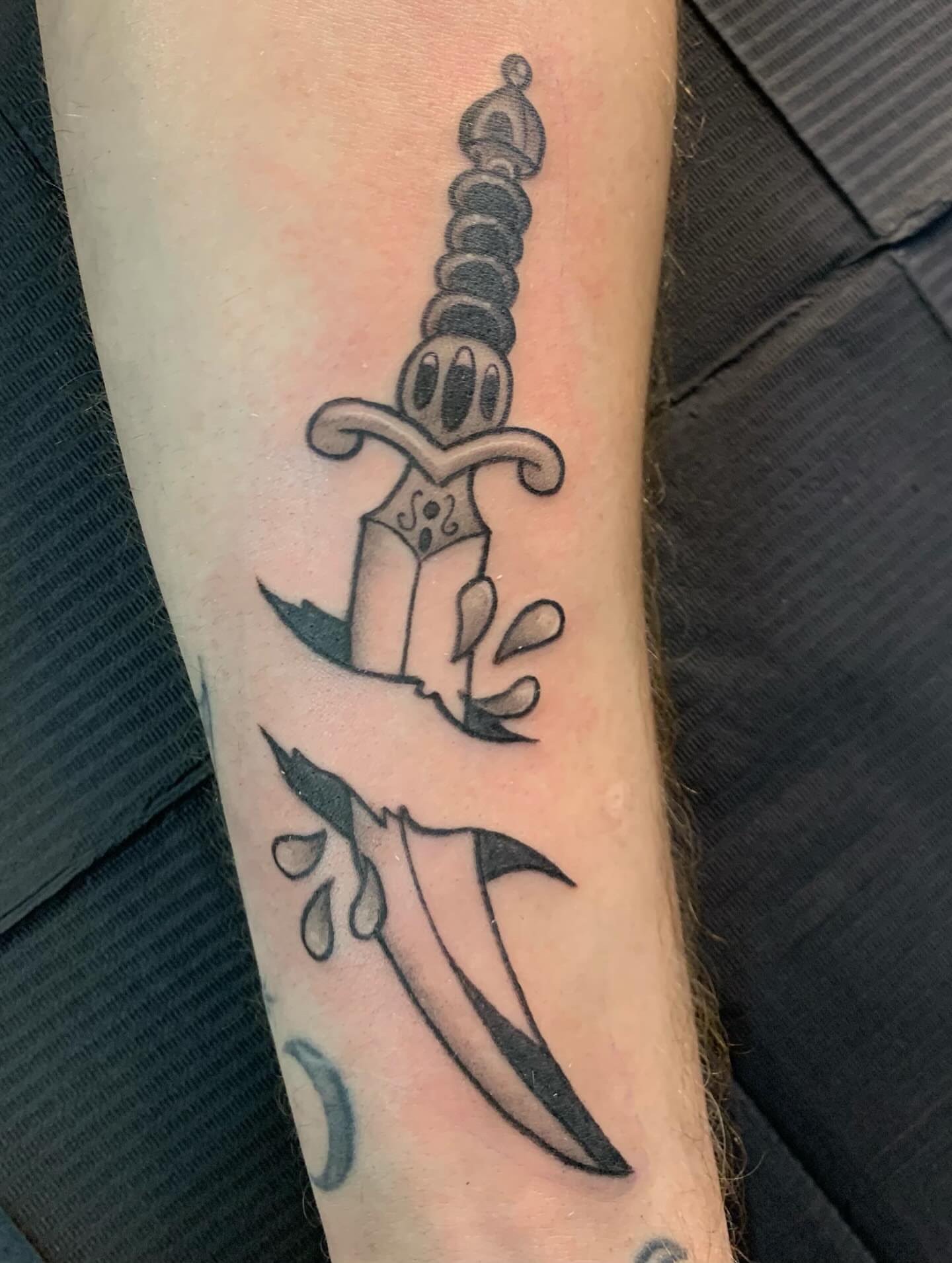 Sword black and grey tattoo on the forearm by Hannah Hahn