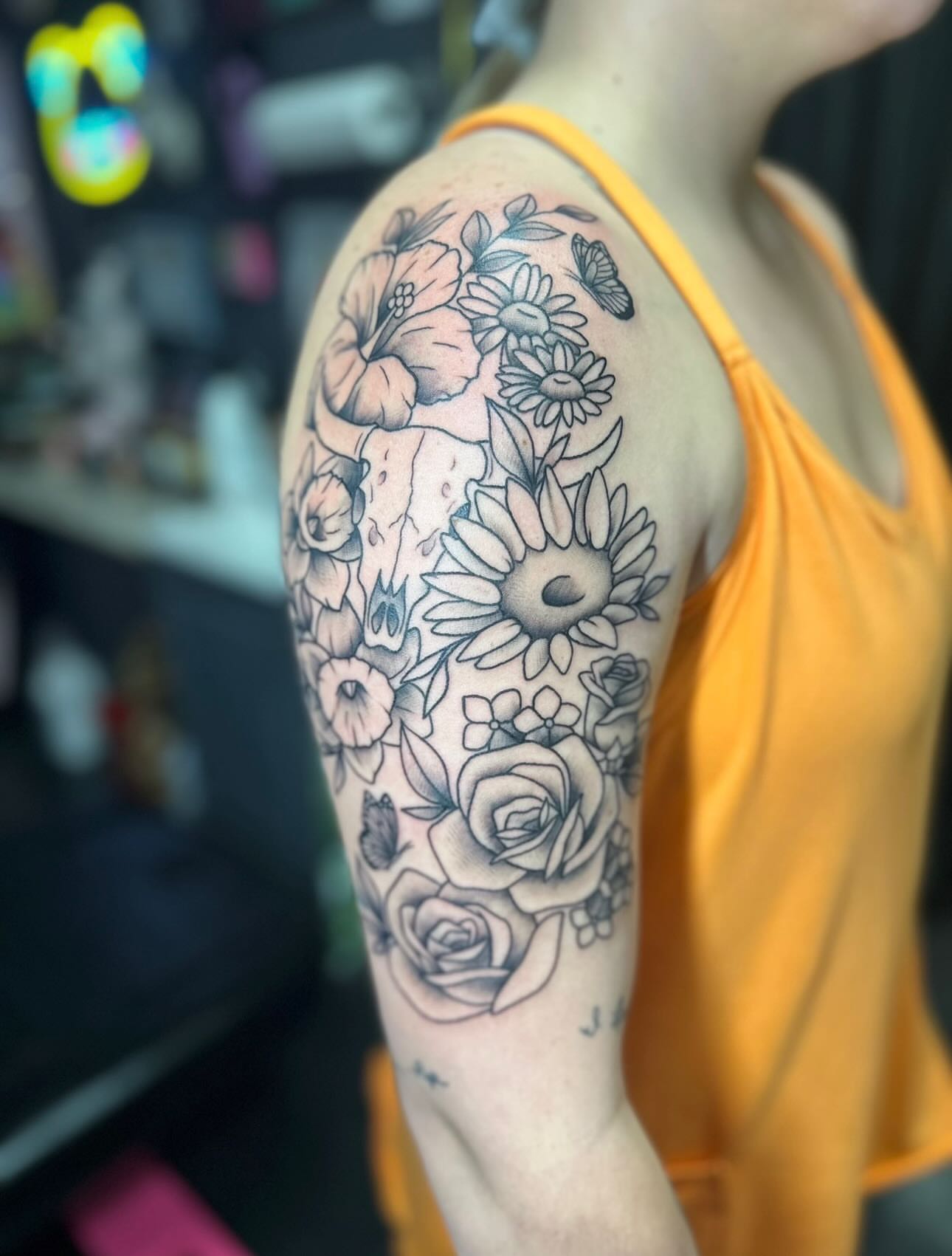 Floral bouquet black and grey tattoo on the shoulder by Tattoo artist