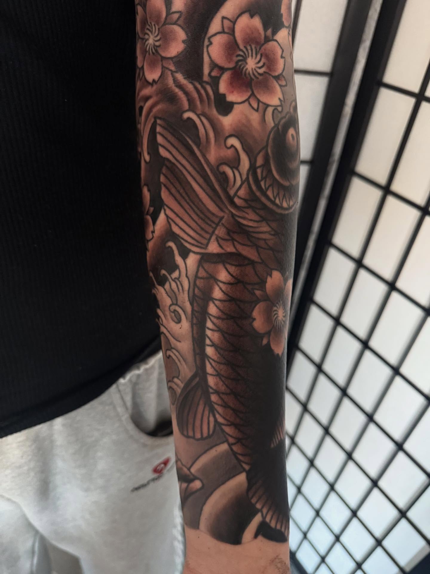 Koi fish and cherry blossoms japanese irezumi tattoo on the forearm by Randall Croley El