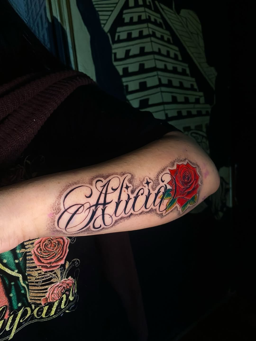Alicia with rose lettering tattoo on the forearm by Irving Guzman
