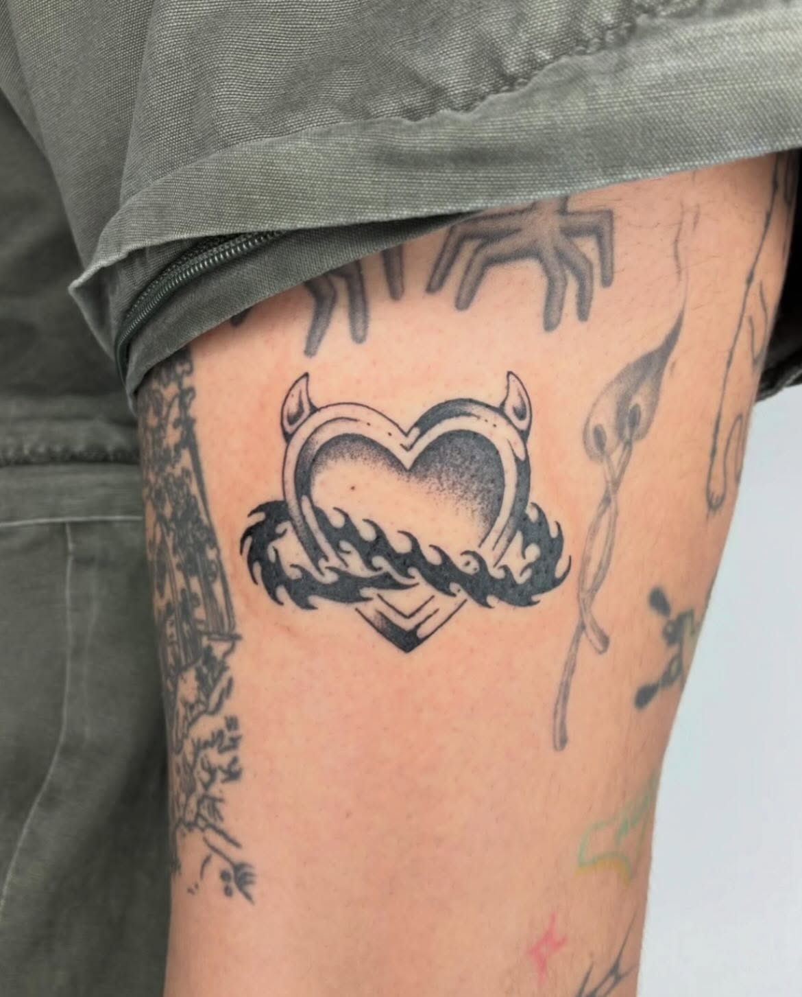 Heart with flames black and grey tattoo on the thigh by Steven Sessler, San Francisco, California