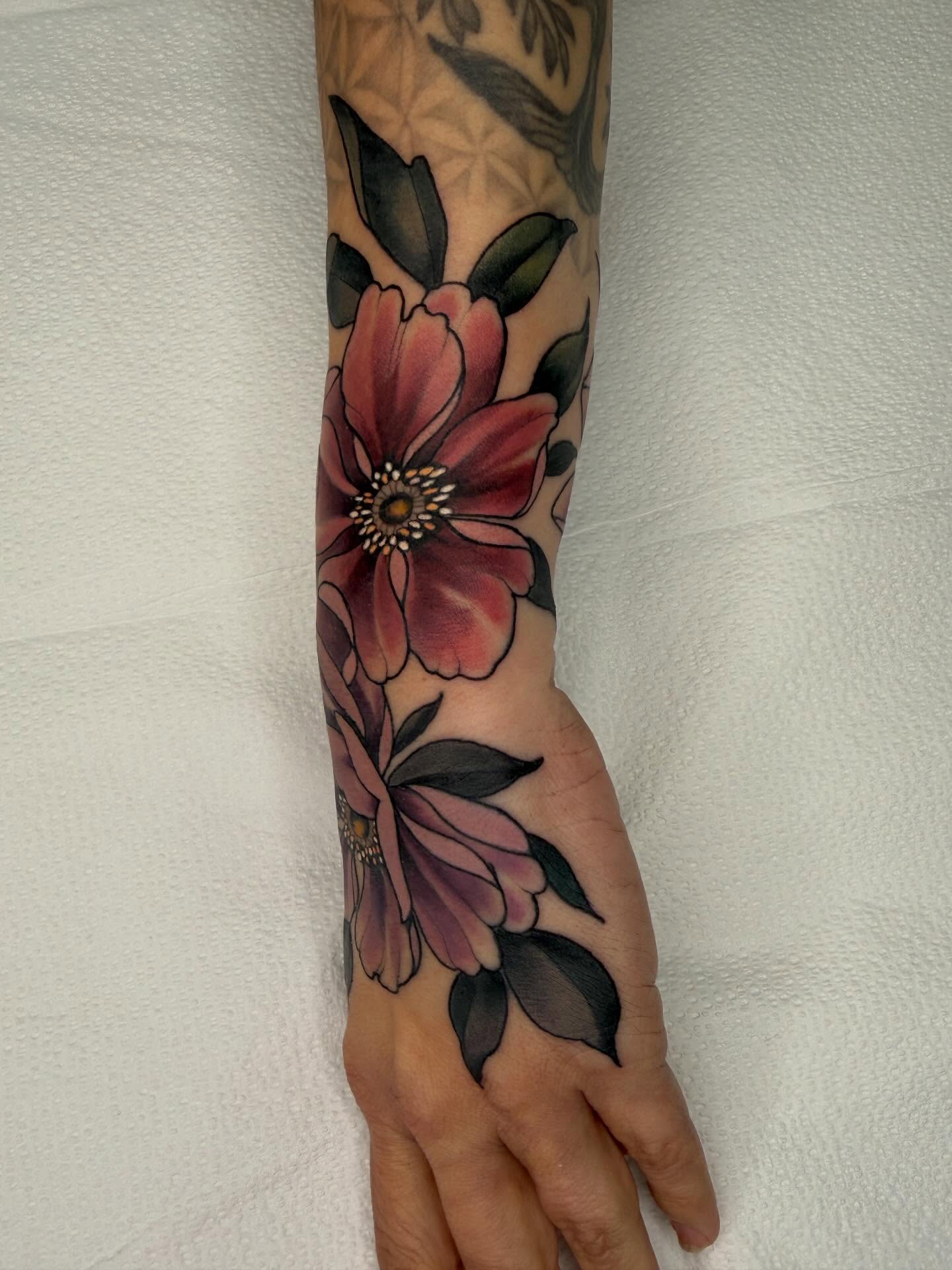 Floral bouquet realism tattoo on the forearm by Samantha Compasso Ford