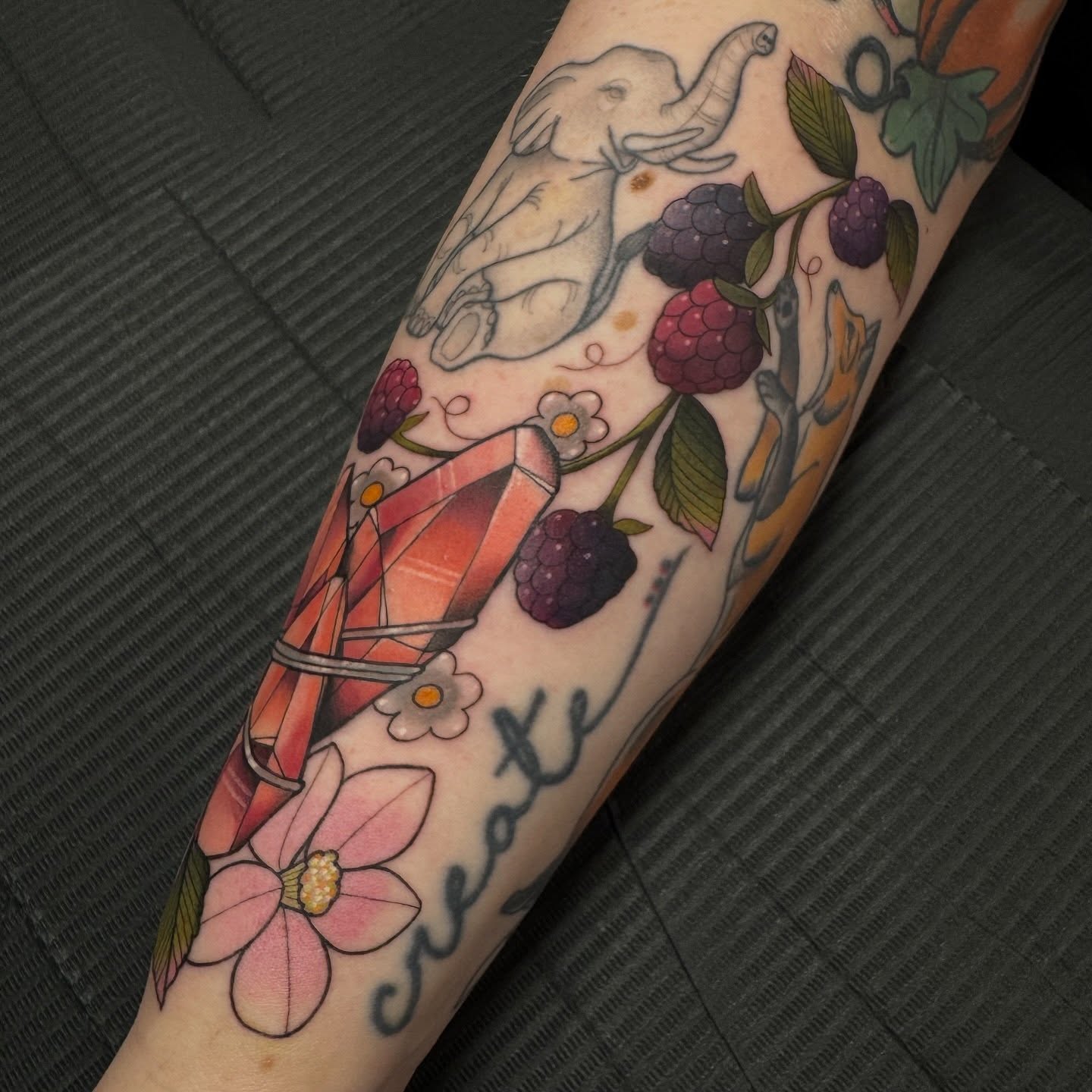 Elephant and berries American traditional tattoo on the forearm by Kaley, Des Moines, Iowa