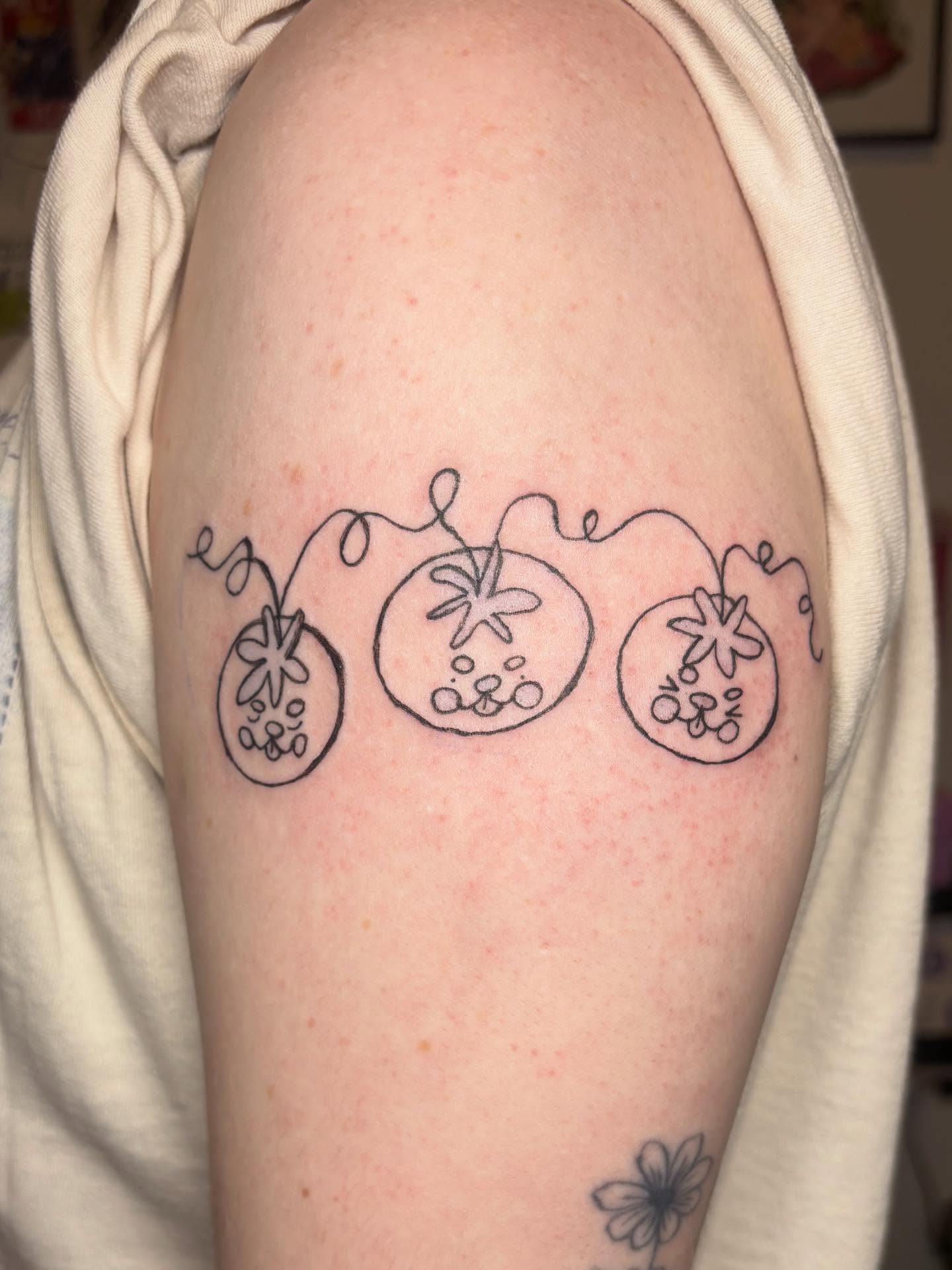 Tomatoes dotwork tattoo on the shoulder by riley