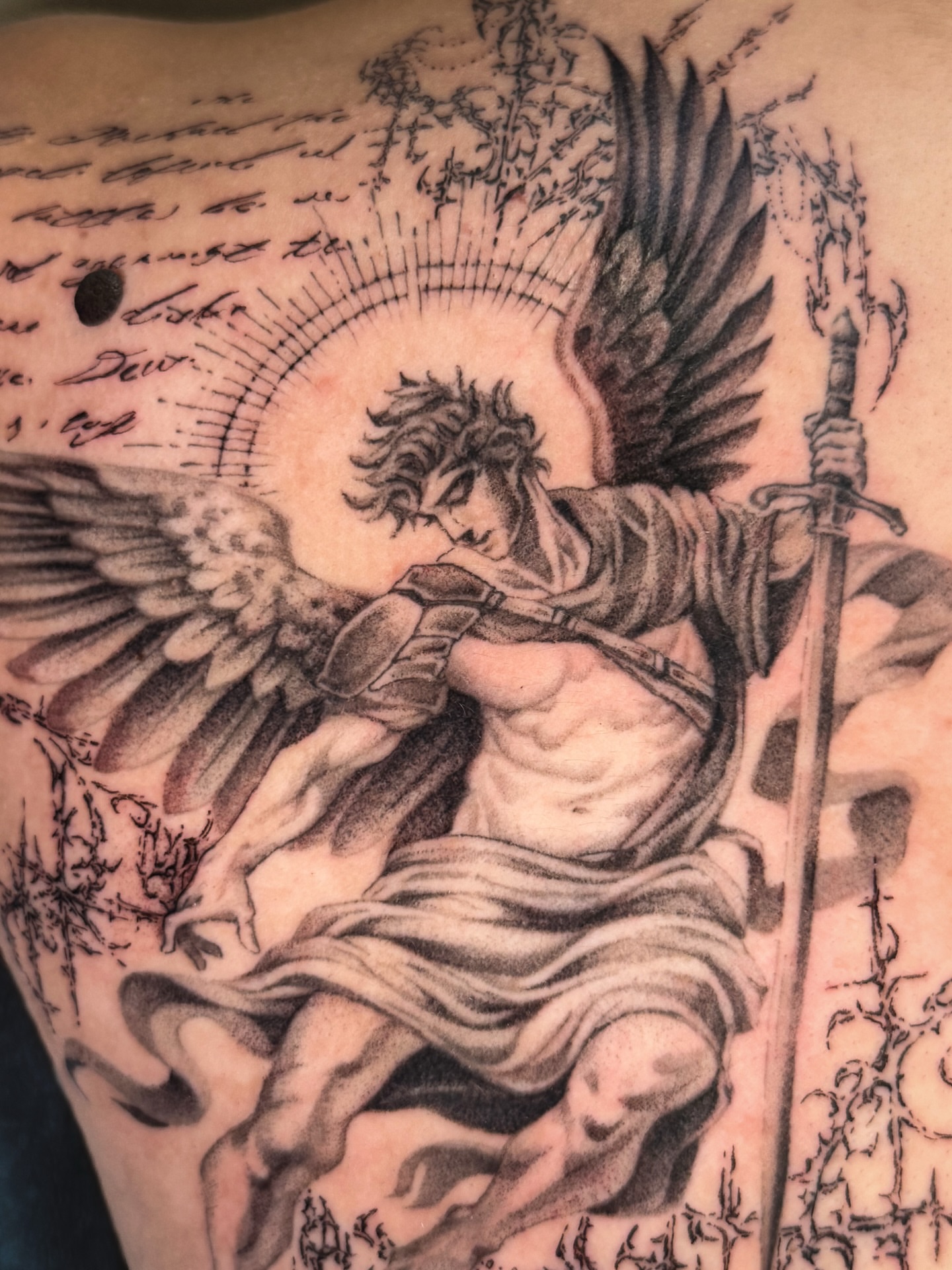 Angel with sword black and grey tattoo on the shoulder by 𝕮𝖞𝖇𝖊𝖗𝕾𝖎𝖌𝖎𝖑𝖎𝖘𝖒
