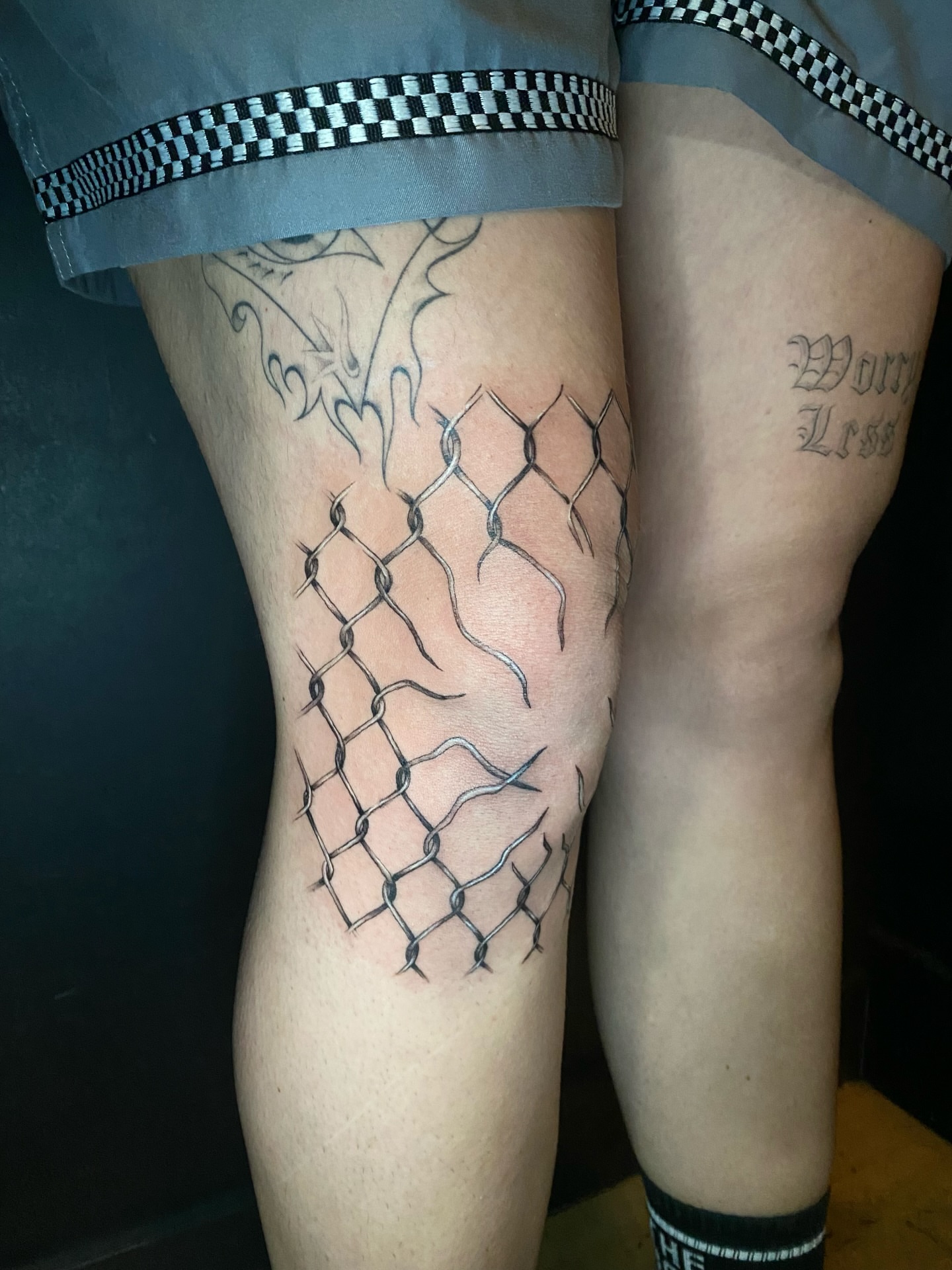 Chain-link fence black and grey tattoo on the thigh by Cherry Jane 🍒