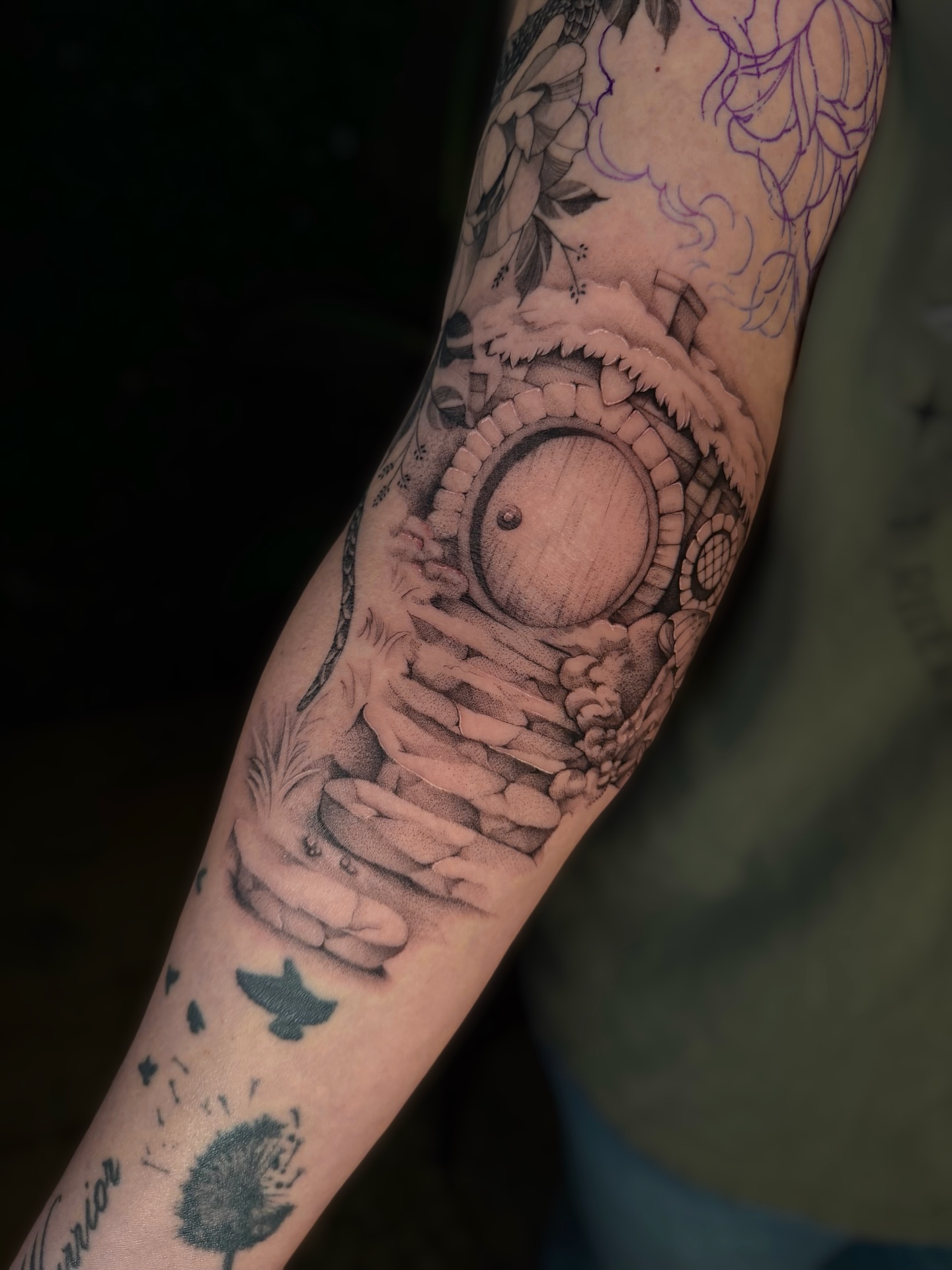Round door with stairs black and grey tattoo on the forearm by Cyn