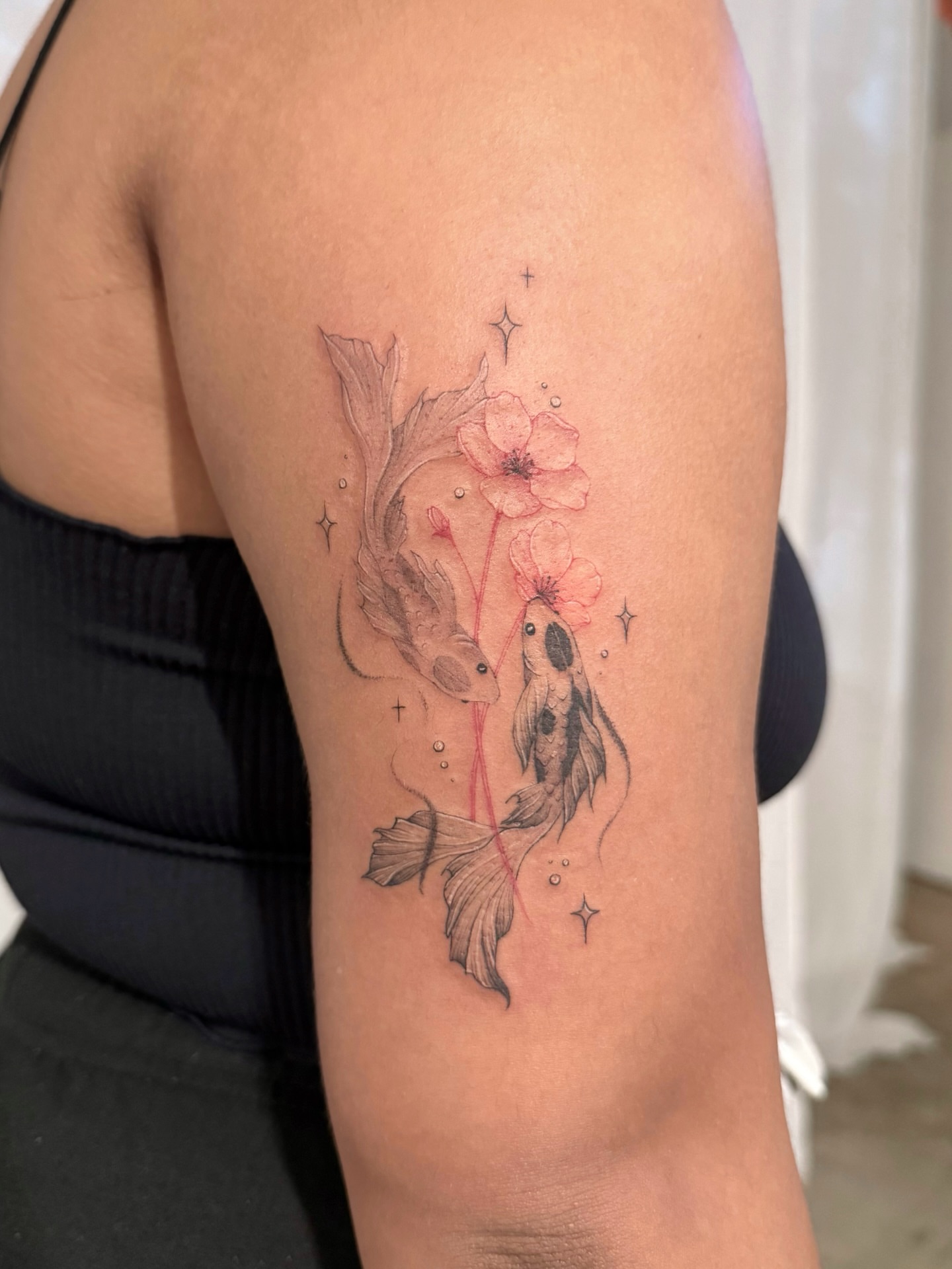 Koi fish and flowers realism tattoo on the upper arm by ๐๐๐๐๐๐