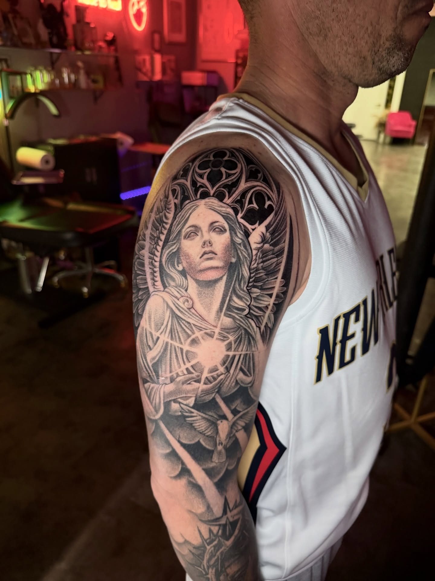 Angelic figure realism tattoo on the upper arm by Tattoo Artist Vanessa