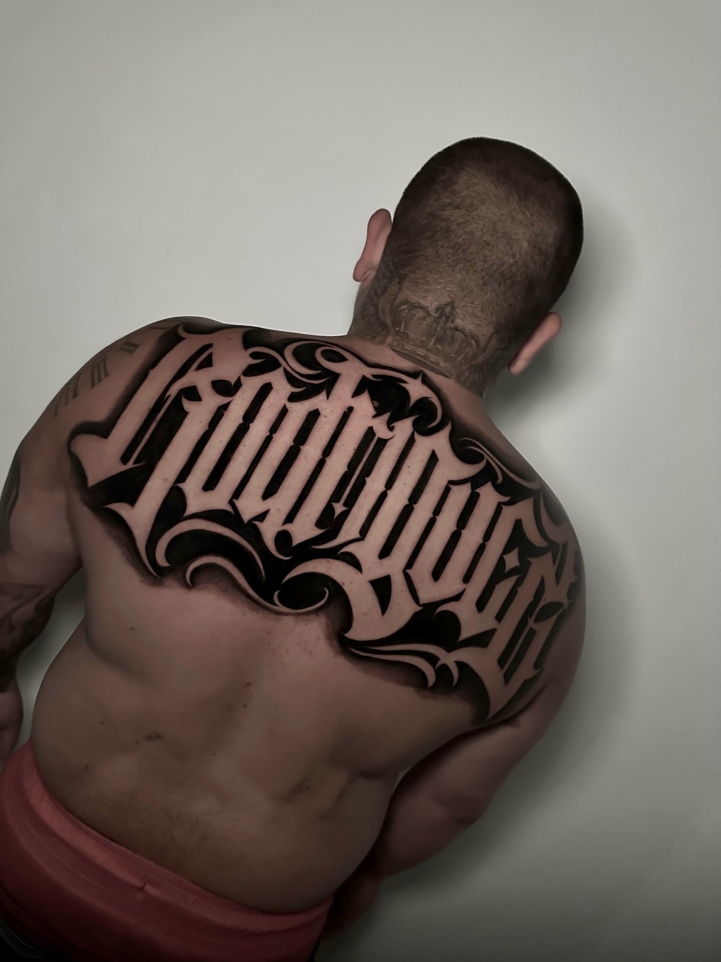 Gothic script lettering script tattoo on the back by Rawb