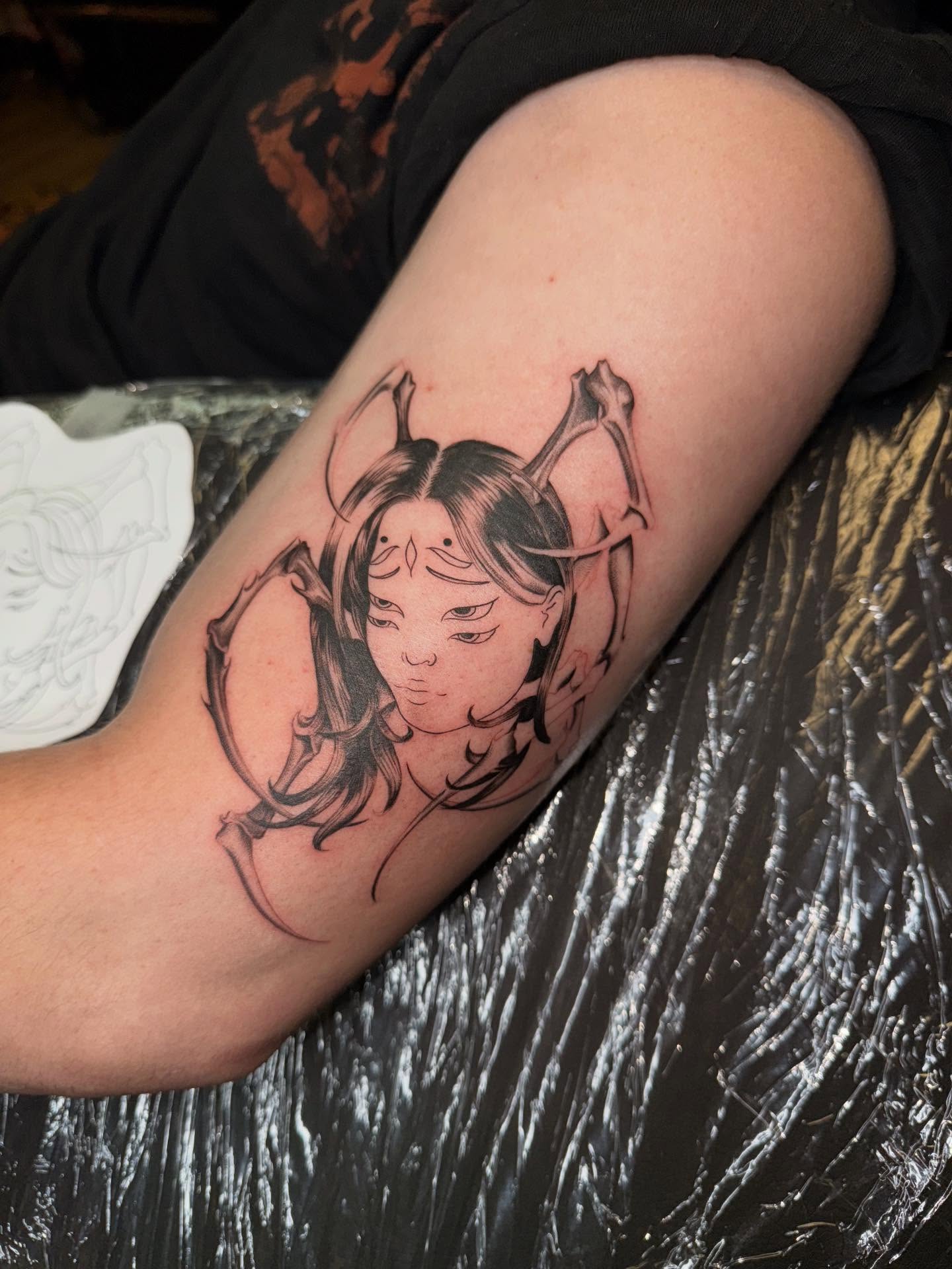 Woman with horns black and grey tattoo on the forearm by Nicki Yến
