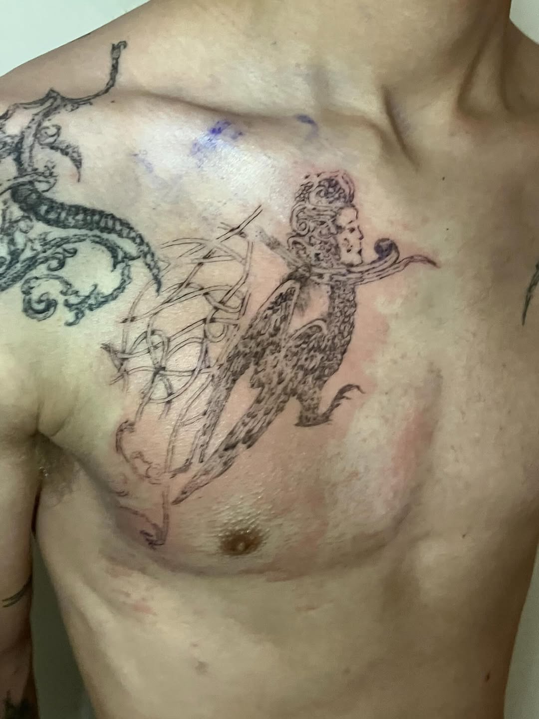 Mythological creature with two faces blackwork tattoo on the chest by Sashka